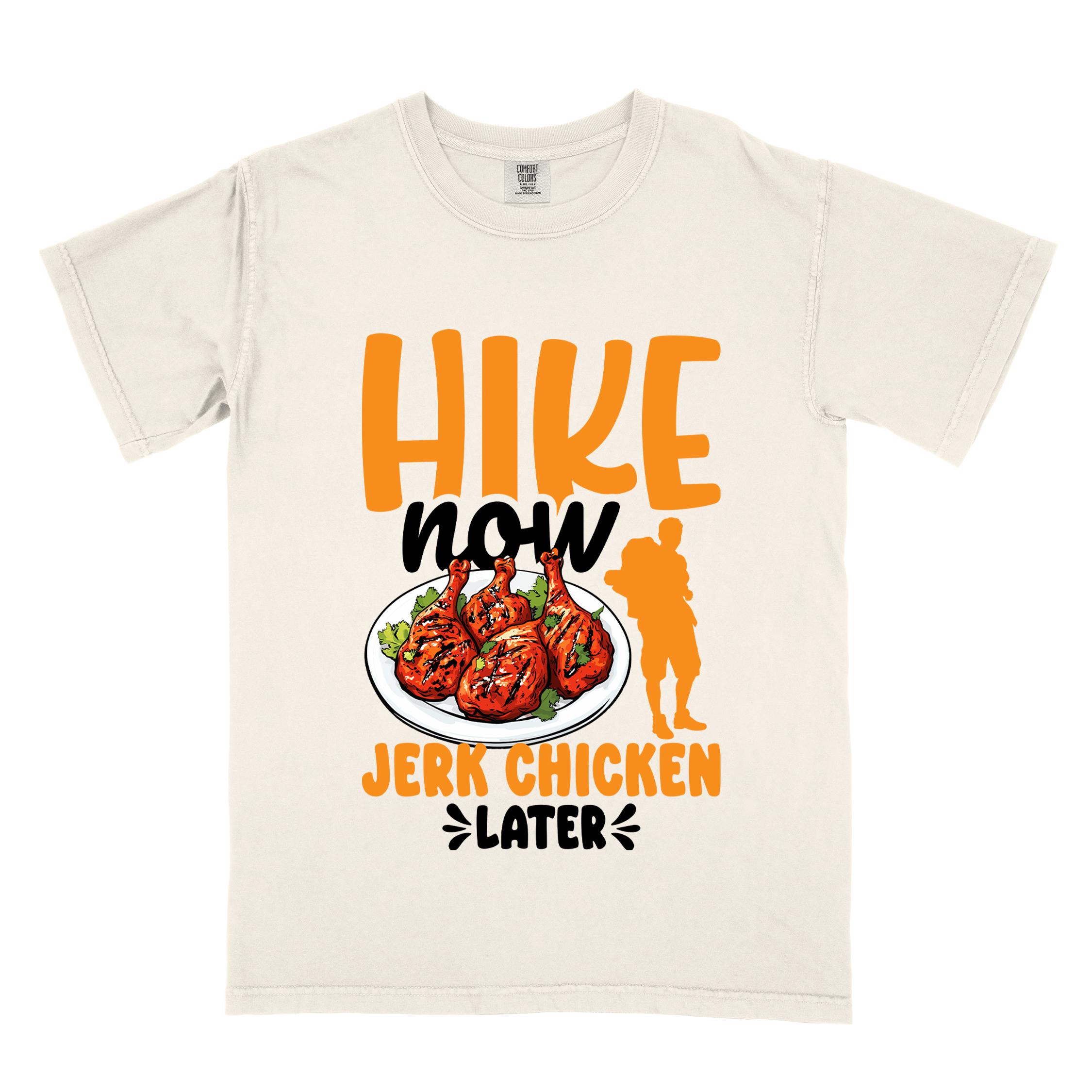 Ivory "hike now jerk chicken later" colored vintage tee with bold typography, illustrated jerk chicken on a plate, mountains, birds, and backpackers for bbq chicken lovers.