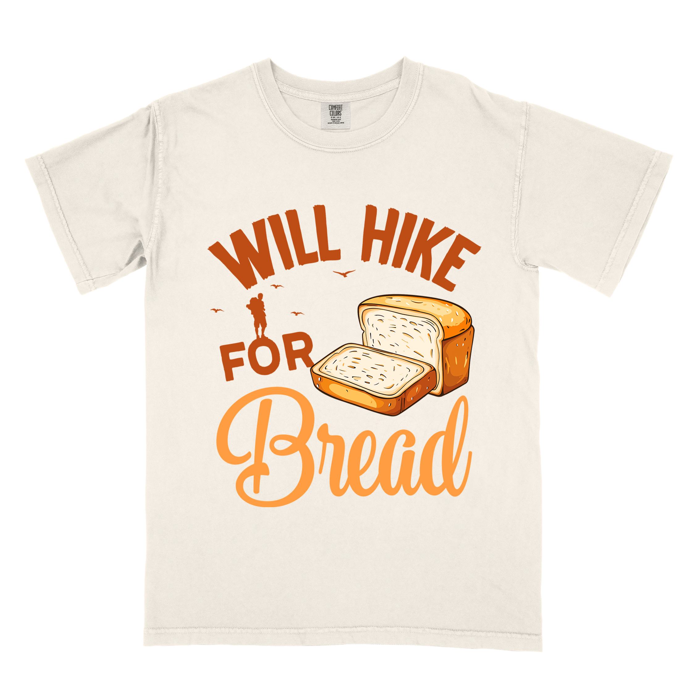 Ivory "Will hike for bread" colored statement tee with flowing script typography, bold lettering, and loaf of bread illustration for pastry-loving outdoor enthusiasts, hikers and foodies
