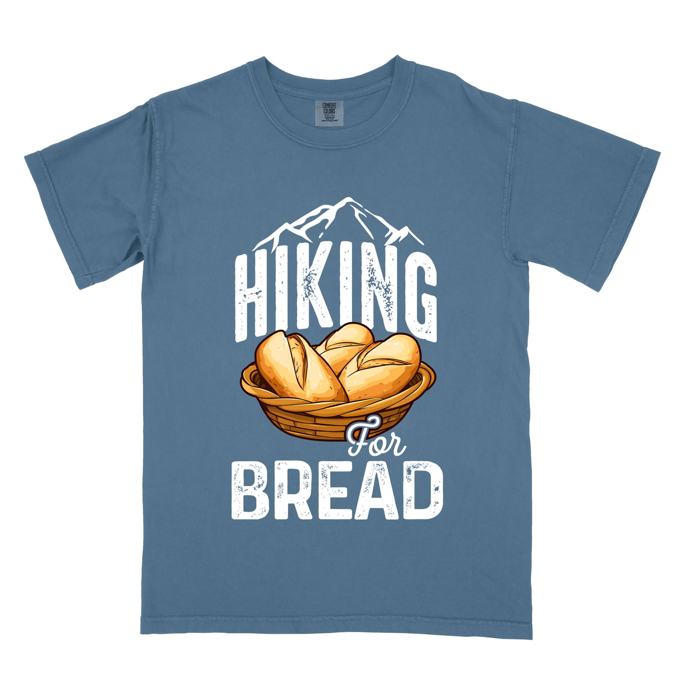blue jean "Hiking for bread" colored statement tee with flowing script typography, bold lettering, and freshly baked bread illustration for pastry-loving outdoor enthusiasts, hikers and foodies