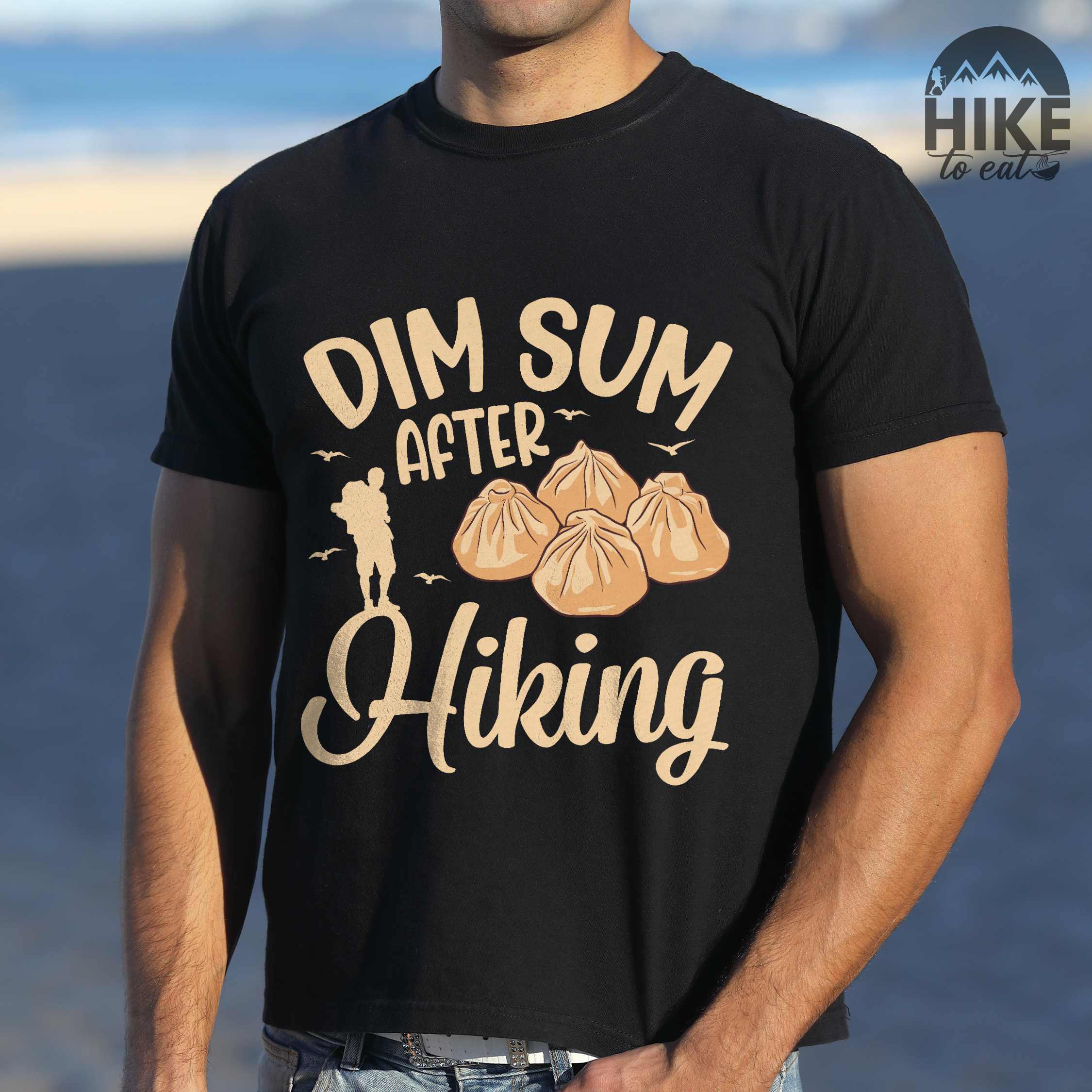 Man wearing black "dim sum after hiking" colored statement tee with bold typography, and steamed dim sum illustration for dim sum-loving outdoor enthusiasts, hikers and foodies