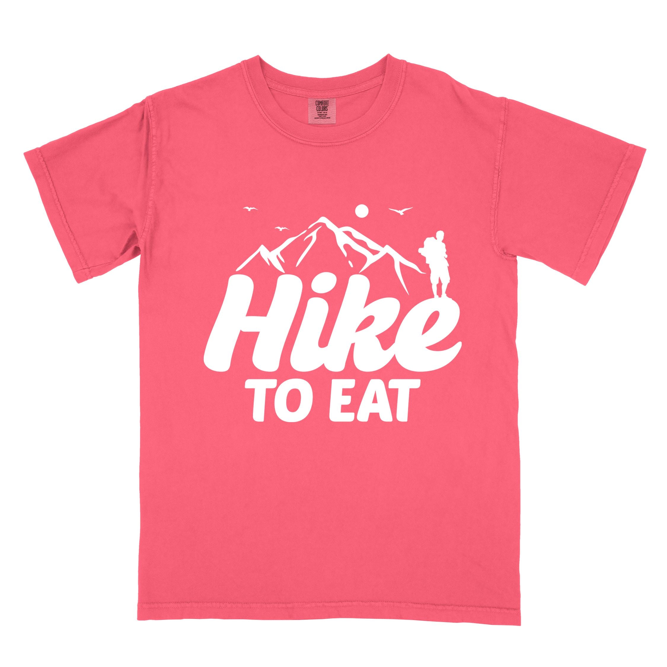 watermelon "Hike to Eat" colored statement tee with bold typography, mountains, birds, sunrise, perfect for food motivated individuals.