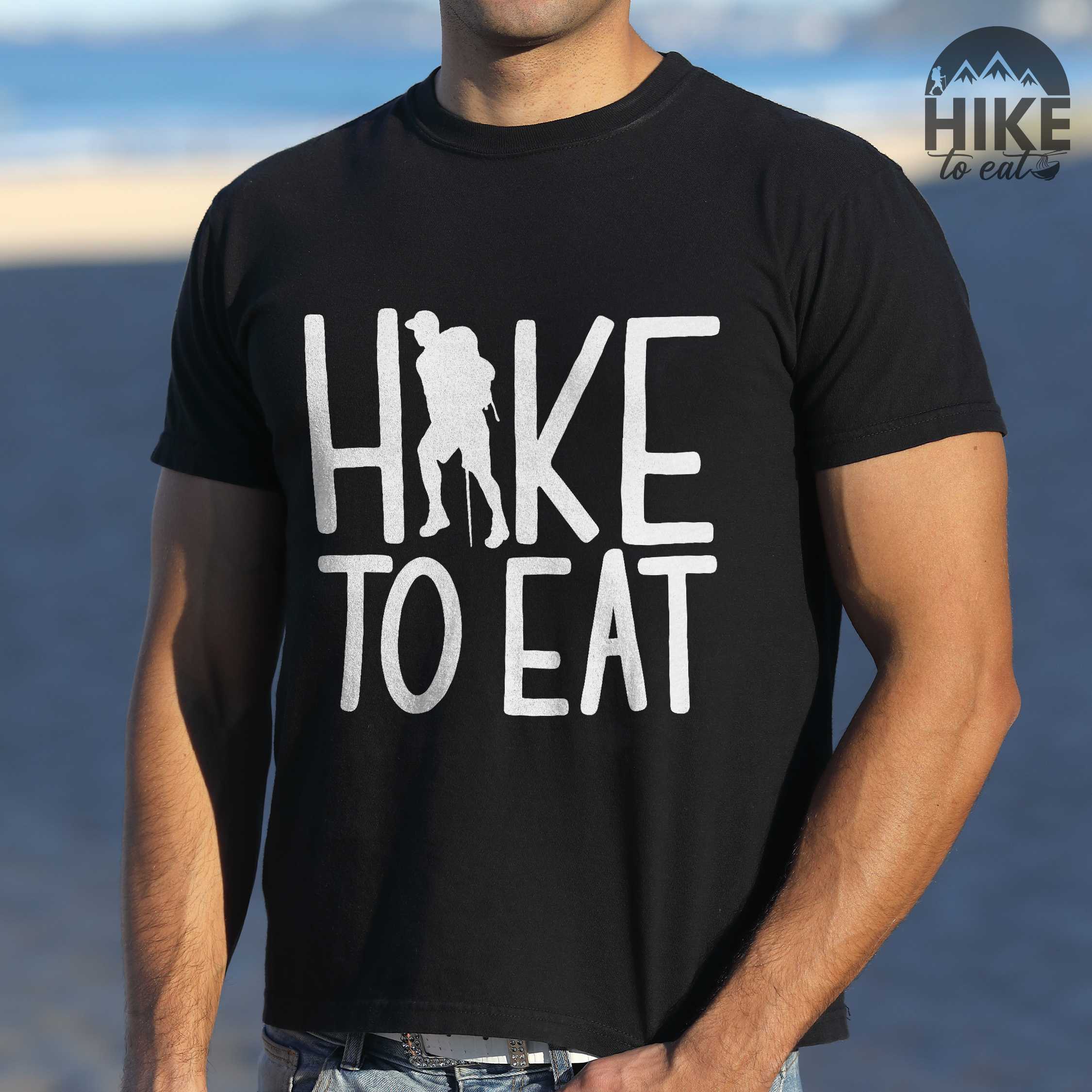 Man wearing black "Hike to Eat" colored statement tee with bold typography, perfect for food motivated individuals.