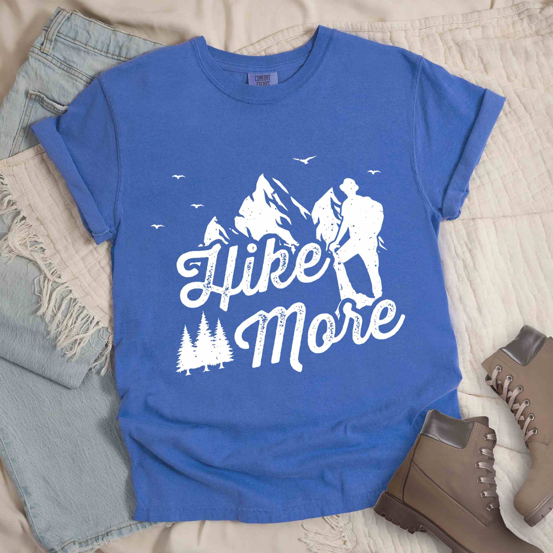 Flo blue "Hike More" colored statement tee with bold typography, mountains, birds, perfect for food motivated individuals.