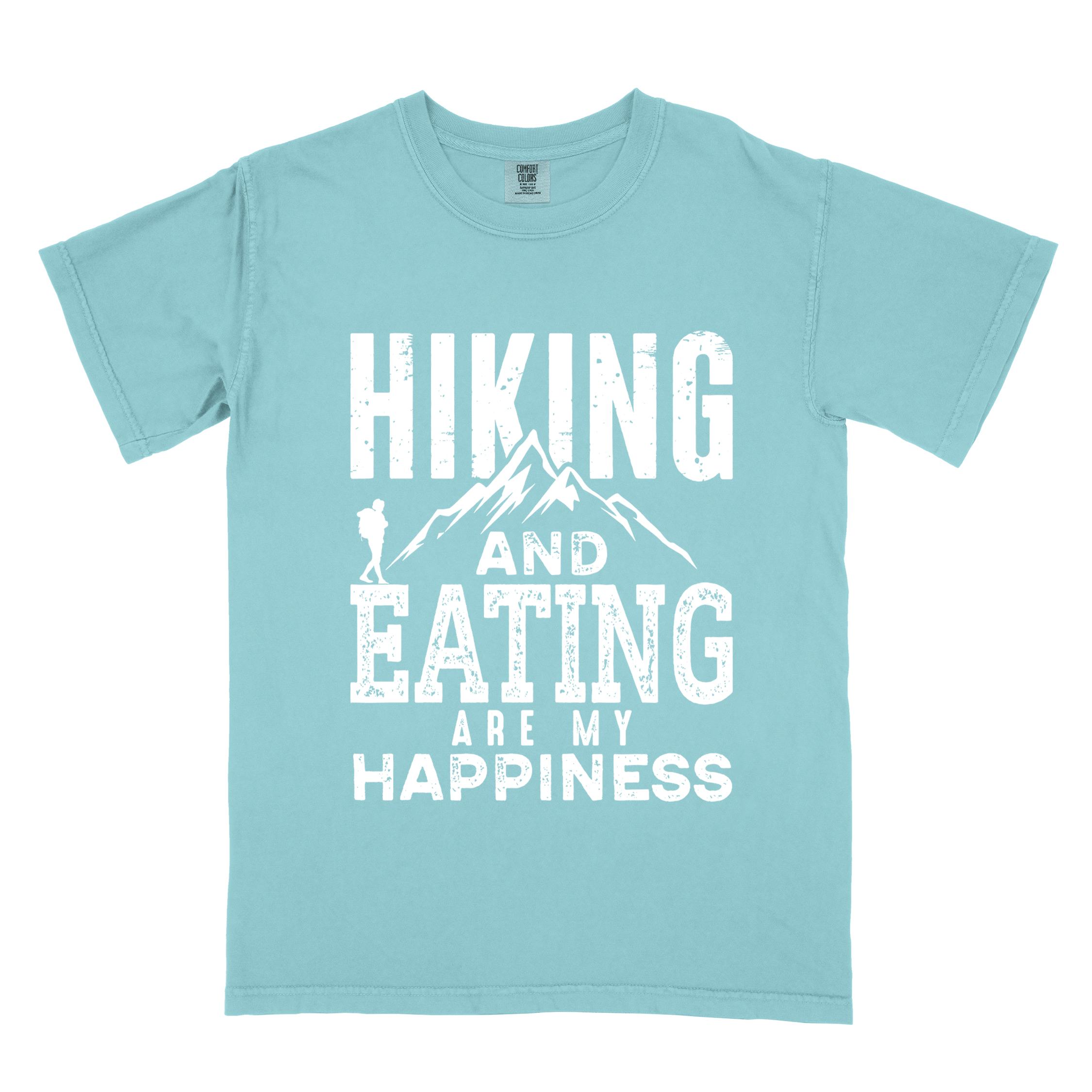 Chalky mint "Hiking and Eating are my happiness" colored statement tee with bold typography, mountains, birds, perfect for adventure motivated individuals.