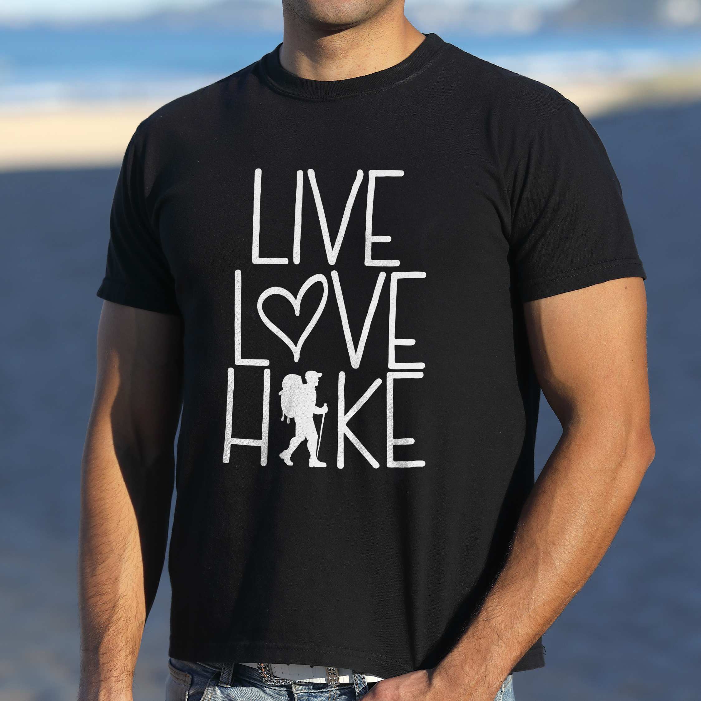 Man wearing black "Live Love hike" colored statement tee with bold typography, perfect for adventure motivated individuals.