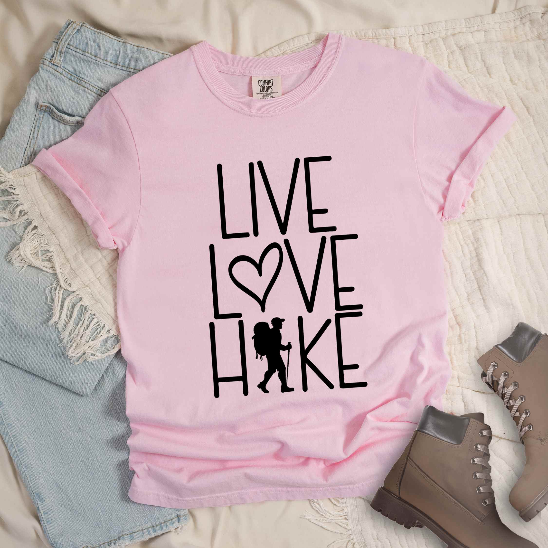 blossom "Live Love hike" colored statement tee with bold typography, perfect for adventure motivated individuals.