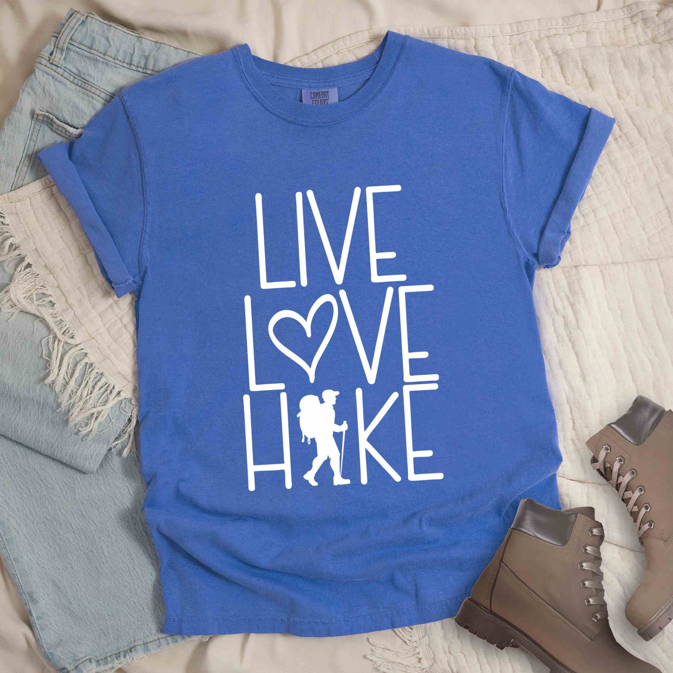 flo blue "Live Love hike" colored statement tee with bold typography, perfect for adventure motivated individuals.