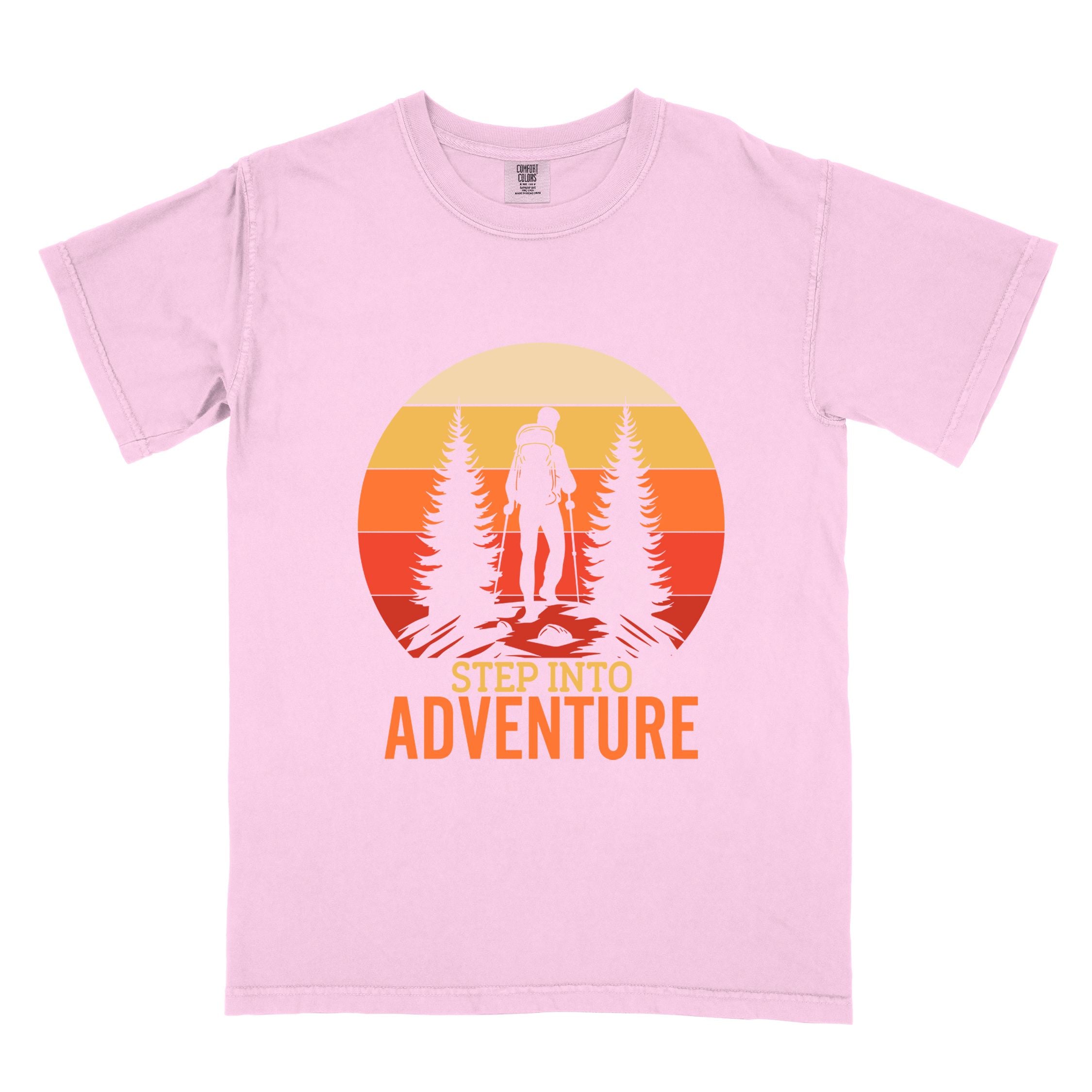 blossom "Step into adventure" colored statement tee with bold typography, mountain, sunrise, perfect for adventure motivated individuals.