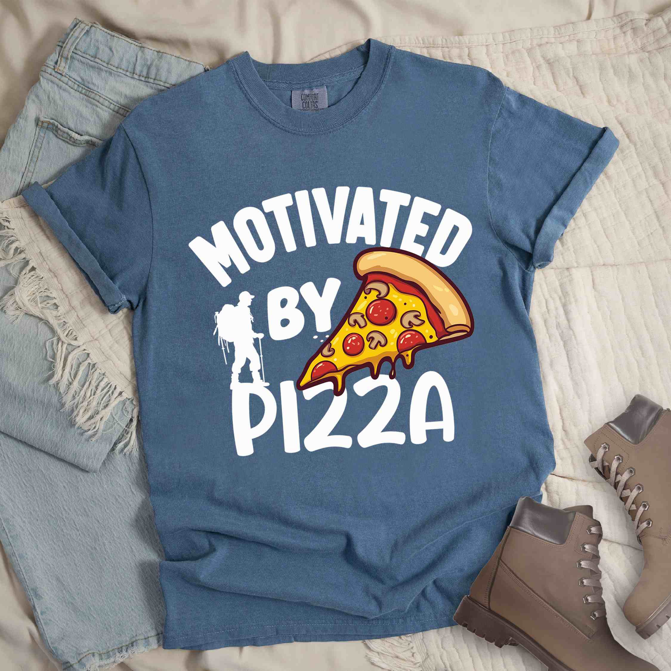 Blue jean Motivated by Pizza colored vintage tee with bold typography, illustrated pizza slice, and backpacker for foodies.