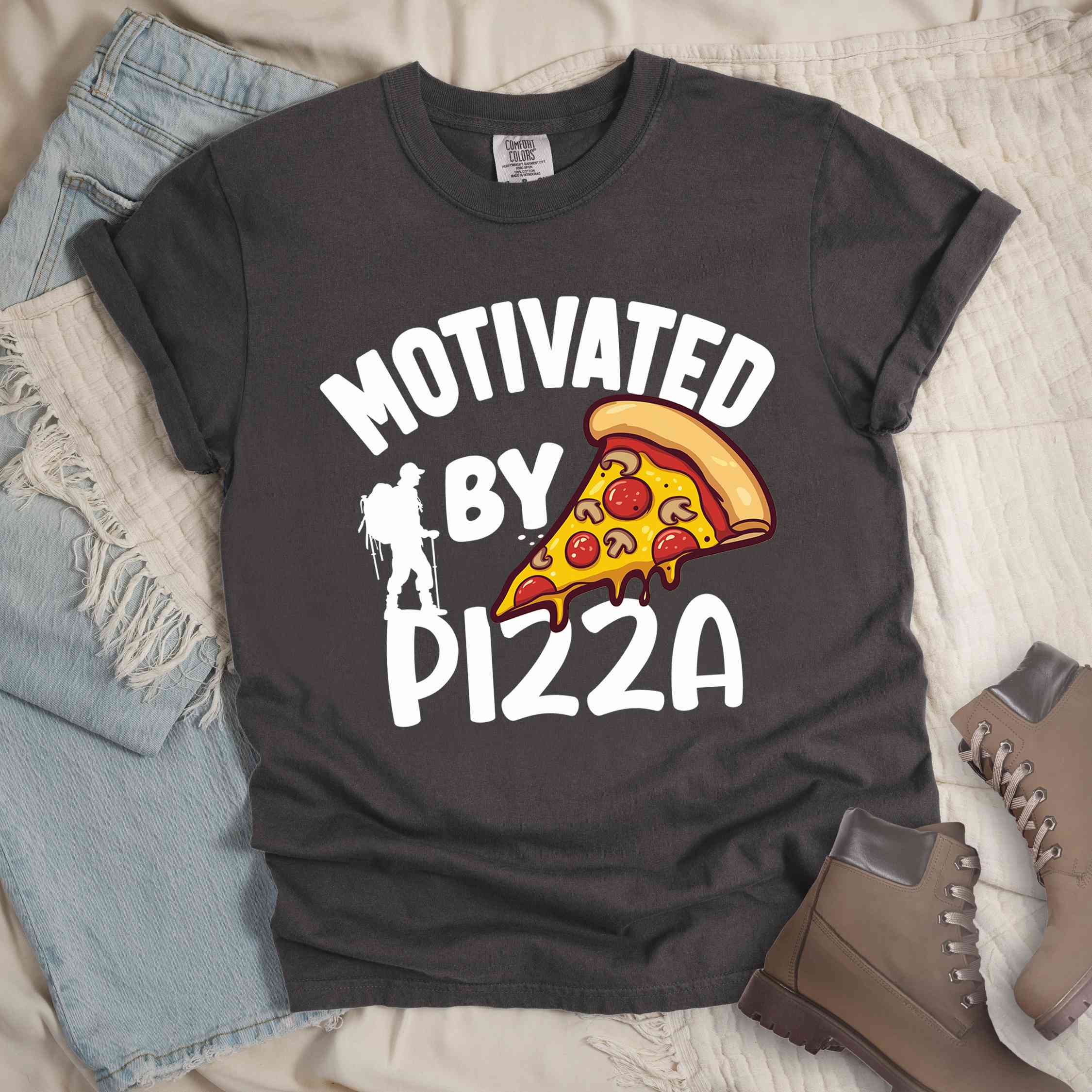 Pepper Motivated by Pizza colored vintage tee with bold typography, illustrated pizza slice, and backpacker for foodies.