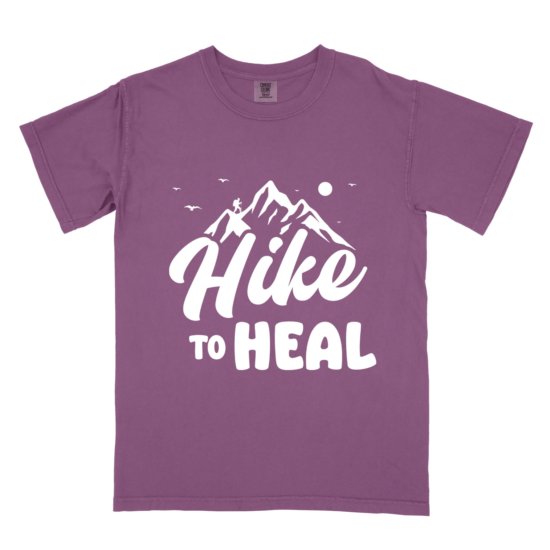 Berry "Hike to Heal" colored statement tee with bold typography, mountain, sunrise, perfect for adventure driven individuals.