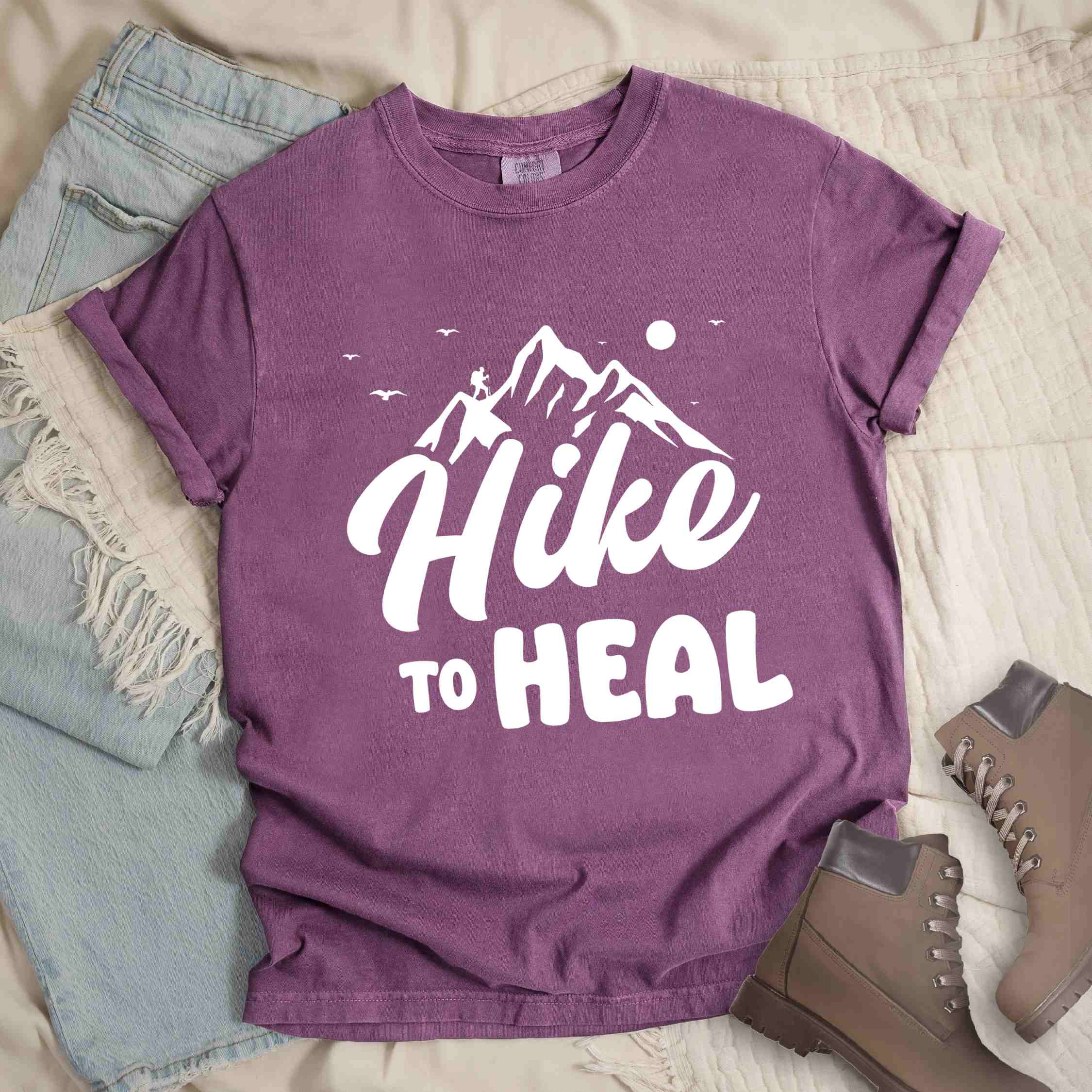 Berry "Hike to Heal" colored statement tee with bold typography, mountain, sunrise, perfect for adventure driven individuals.