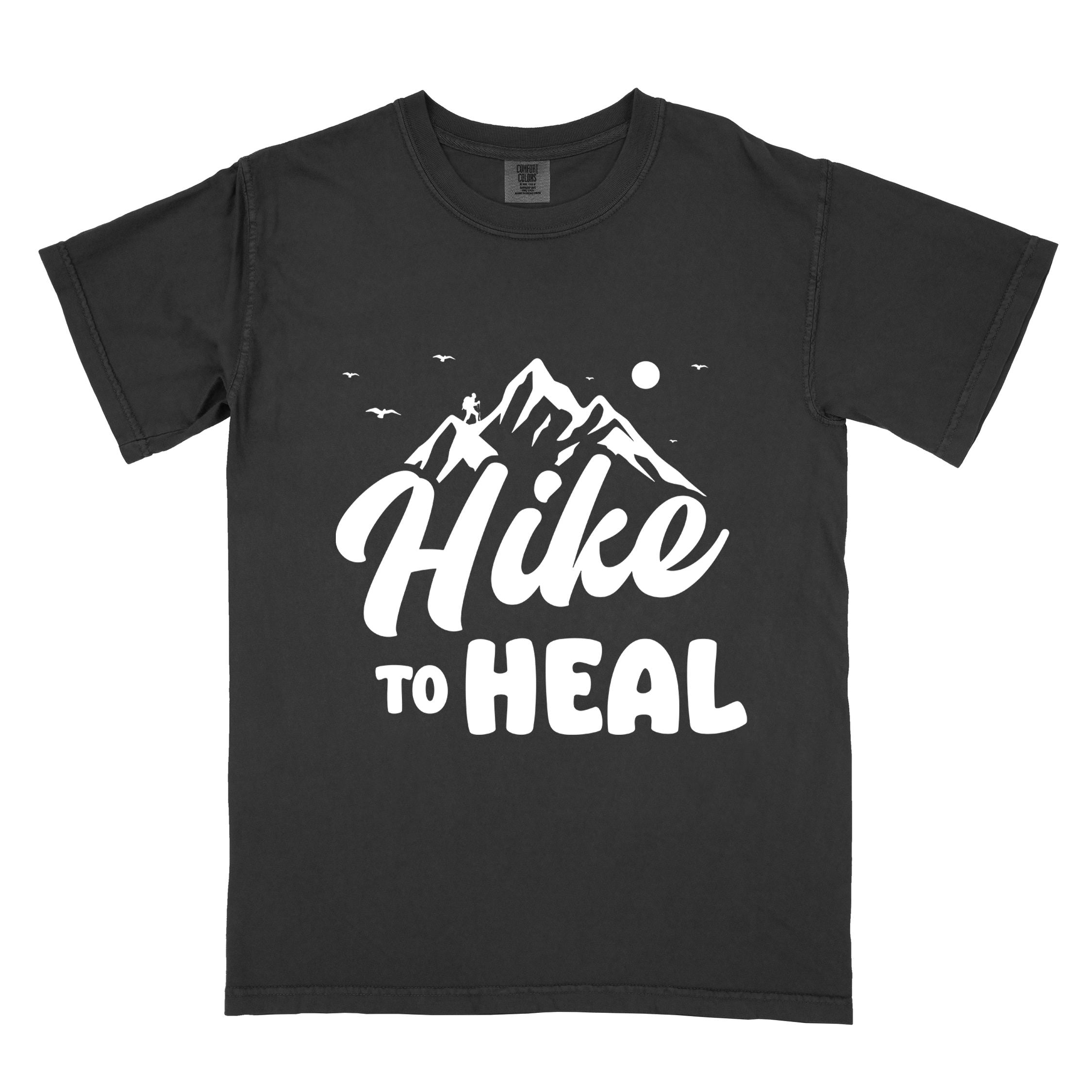 Black "Hike to Heal" colored statement tee with bold typography, mountain, sunrise, perfect for adventure driven individuals.
