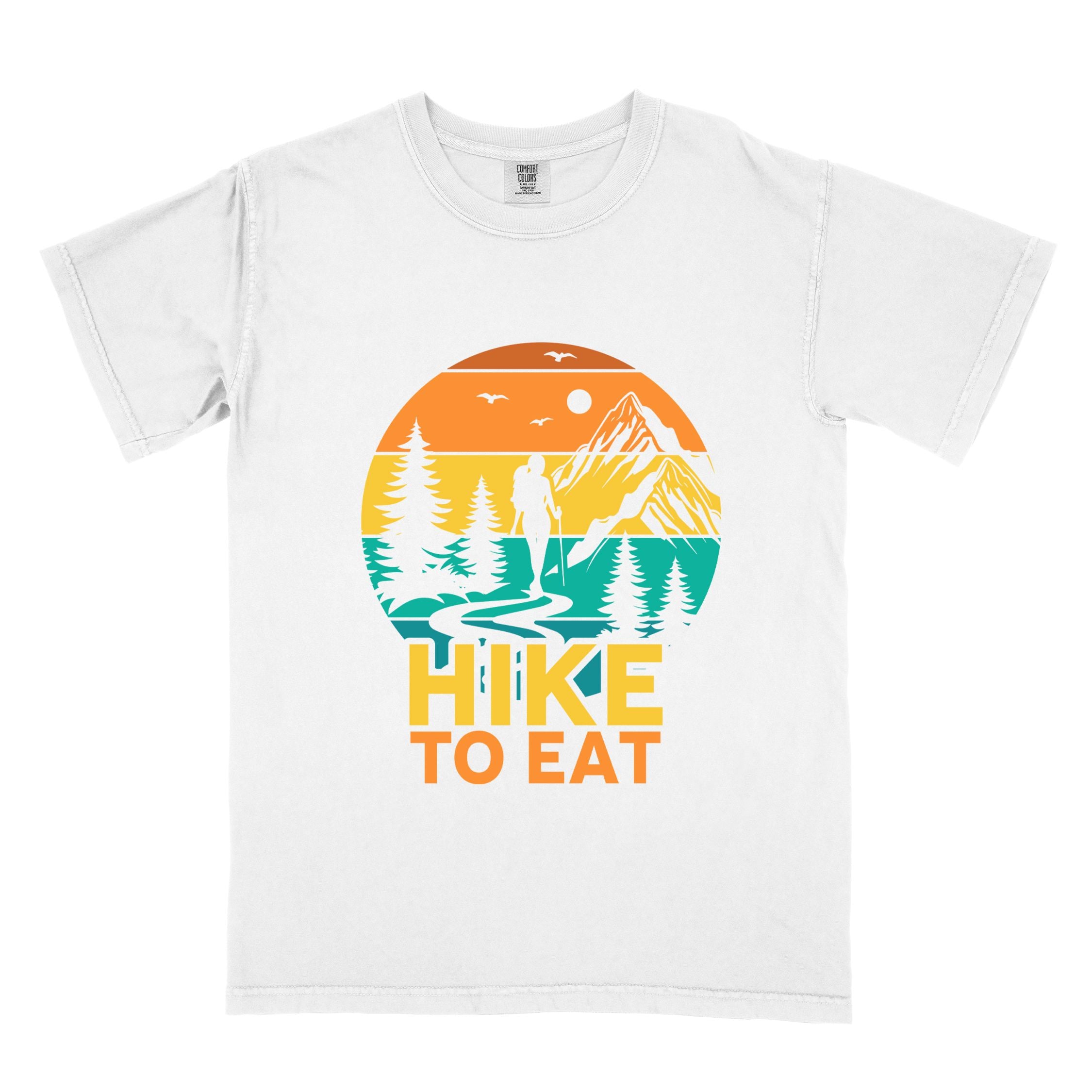 White "Hike to Eat" colored statement tee with bold typography, mountain, sunrise, perfect for adventure driven individuals.