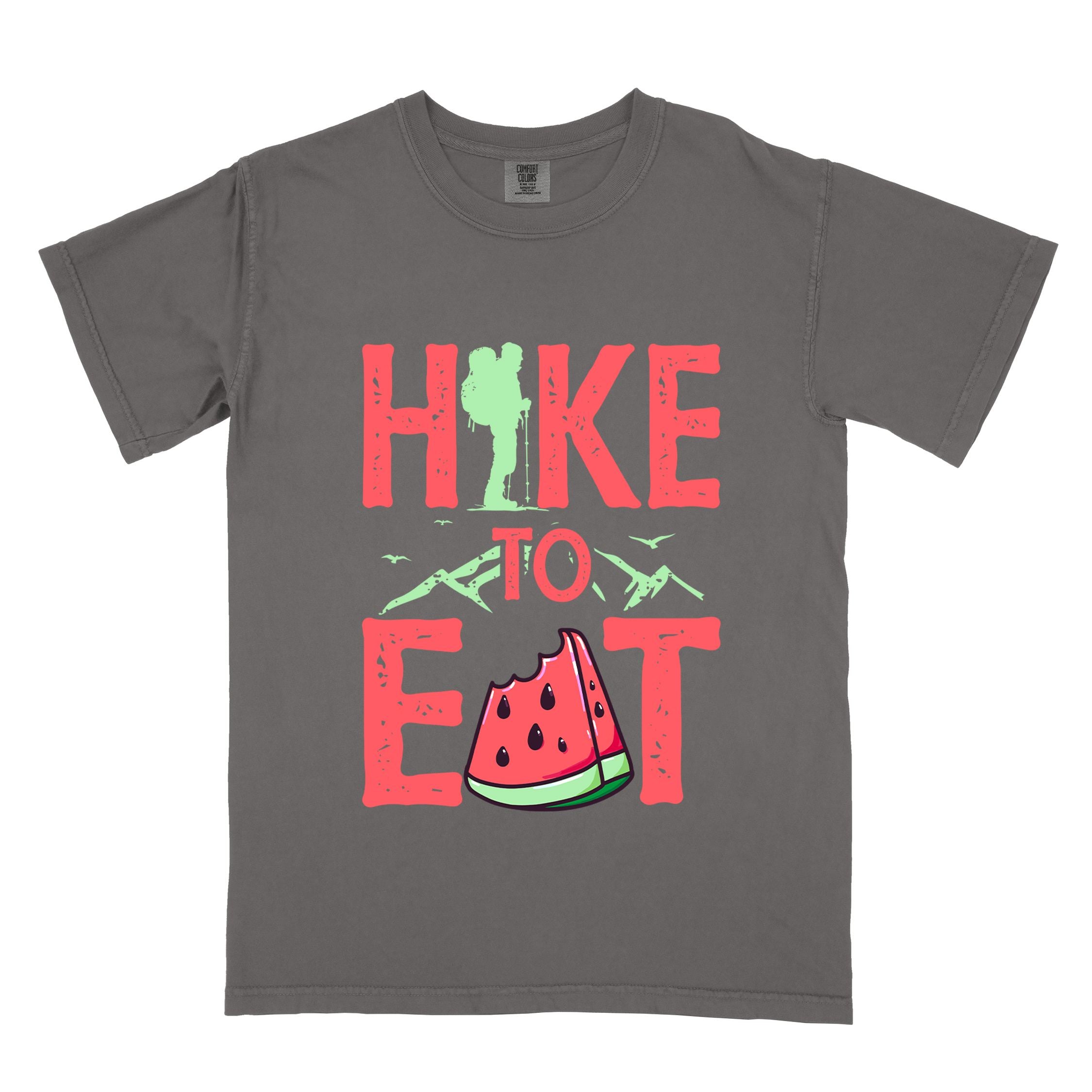 Pepper "Hike to Eat" colored statement tee with bold typography, mountain, illustrated slice of watermelon, perfect for fruit lovers.