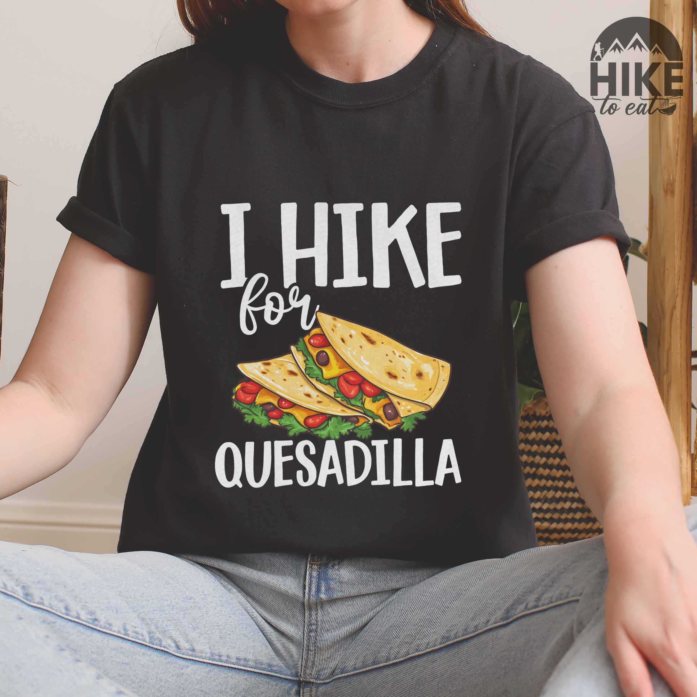 Woman wearing black I Hike for Quesadilla colored vintage tee with bold typography, illustrated quesadilla wrap for backpackers with the craving for quesadillass who love Mexican food