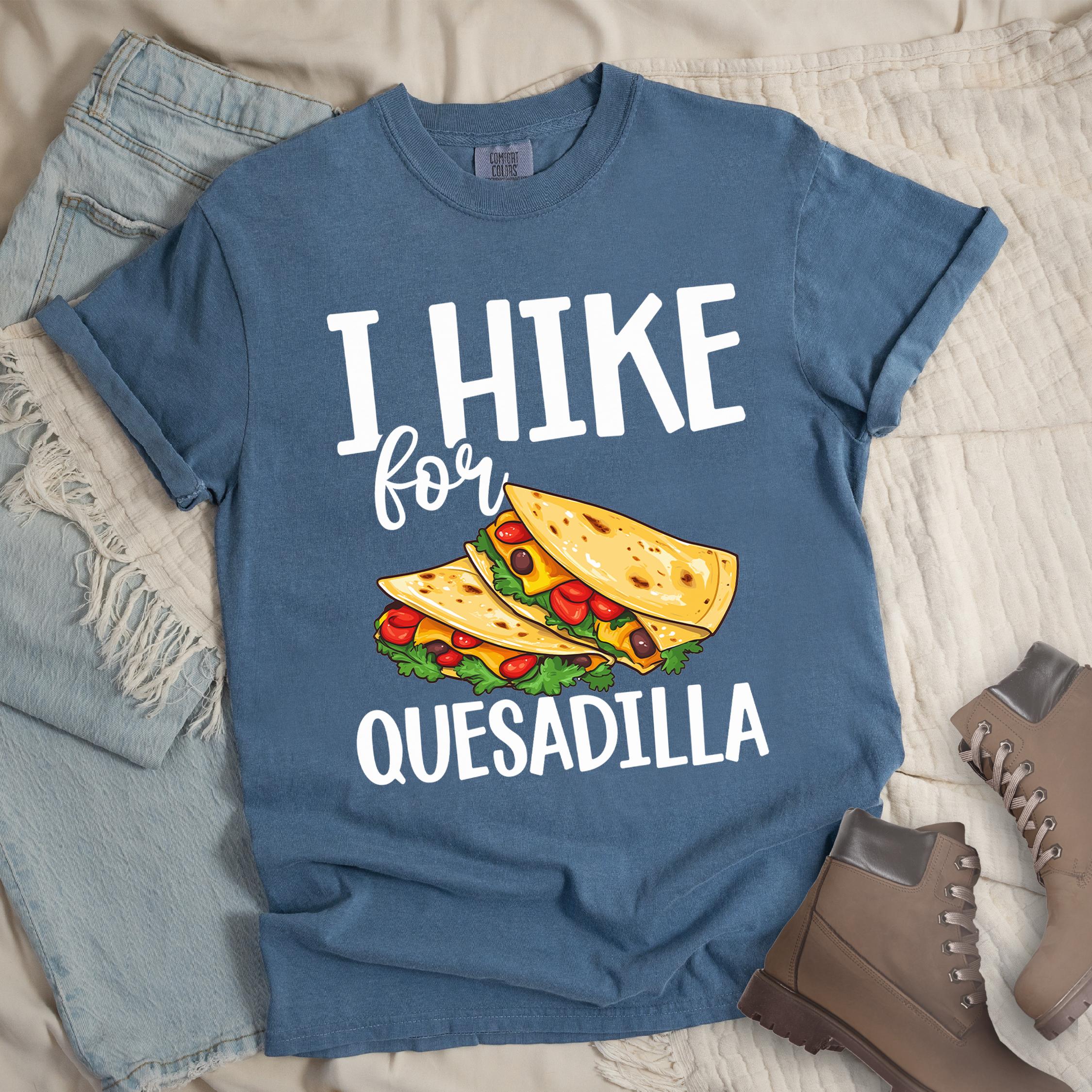 Dark blue shirt with “I Hike for Quesadilla” text, featuring two folded quesadillas filled with cheese, tomatoes, and lettuce.