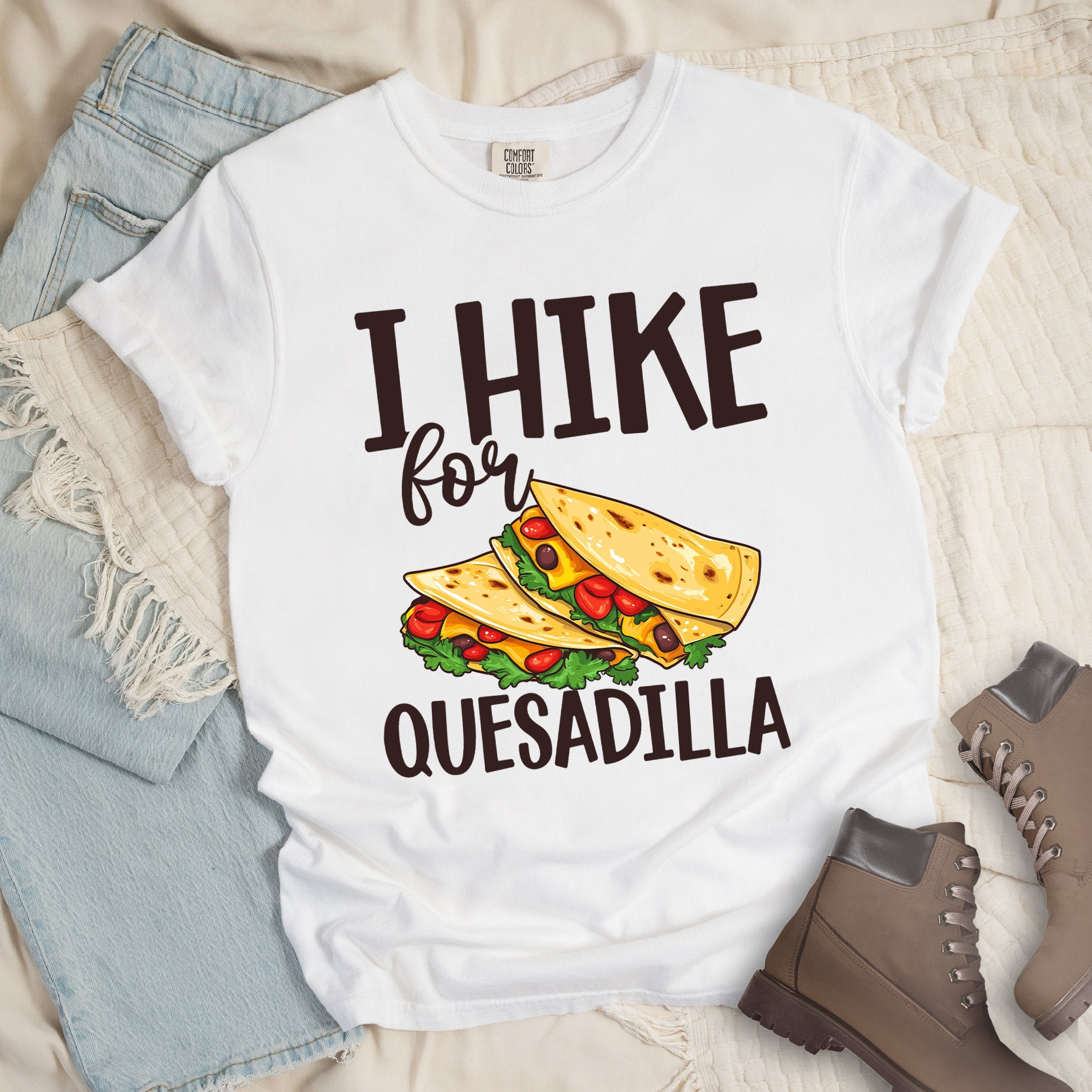 White shirt with “I Hike for Quesadilla” text, featuring two folded quesadillas filled with cheese, tomatoes, and lettuce.