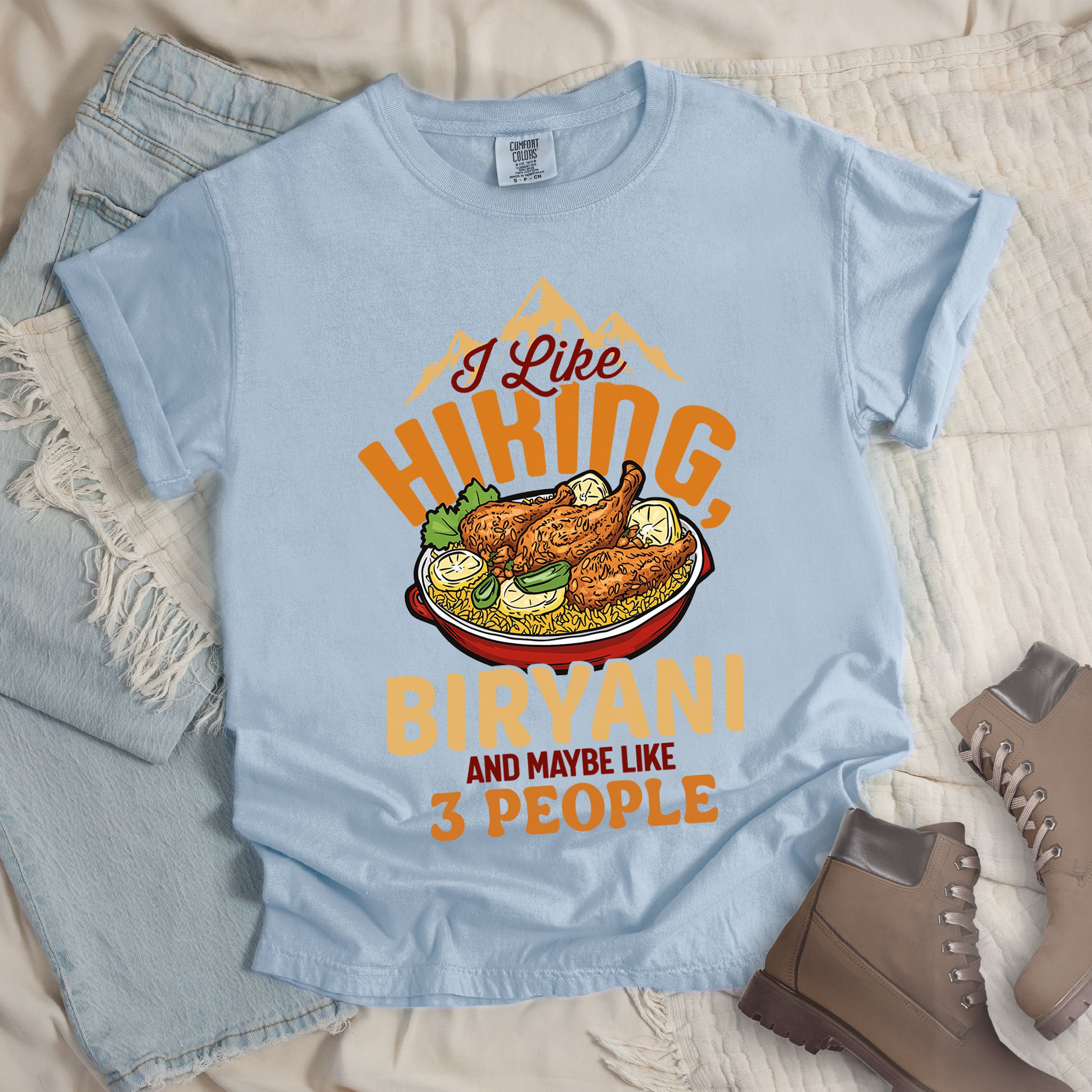 Light blue shirt with “I Like Hiking, Biryani and Maybe Like 3 People” in bold orange text, featuring a steaming bowl of biryani with chicken, lemon wedges, and herbs.