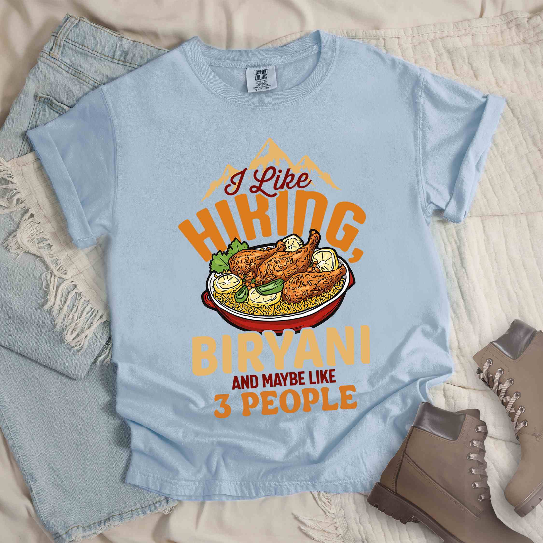 Chambray “I Like Hiking, Biryani and Maybe Like 3 People” colored vintage tee with bold text, featuring a steaming bowl of biryani with chicken, lemon wedges, and herbs. Perfect tee for biryani rice lovers.
