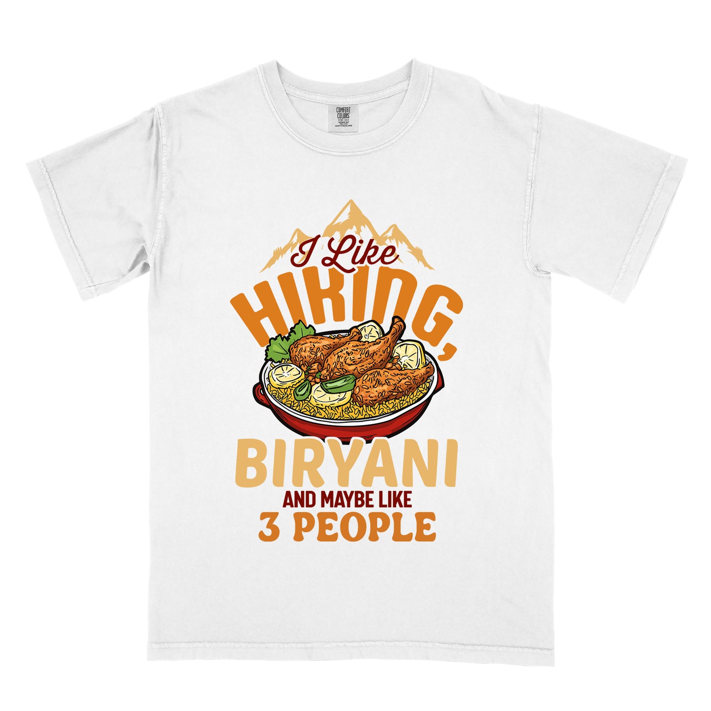 White t-shirt with text reading "I Like HIKING, BIRYANI AND MAYBE LIKE 3 PEOPLE". Gold mountain silhouettes appear above "I Like" (in dark brown script). "HIKING" is in large orange letters, below which sits a detailed illustration of a red bowl filled with biryani rice and chicken. "BIRYANI" appears in gold letters, while "AND MAYBE LIKE" is in small dark brown text and "3 PEOPLE" in orange.