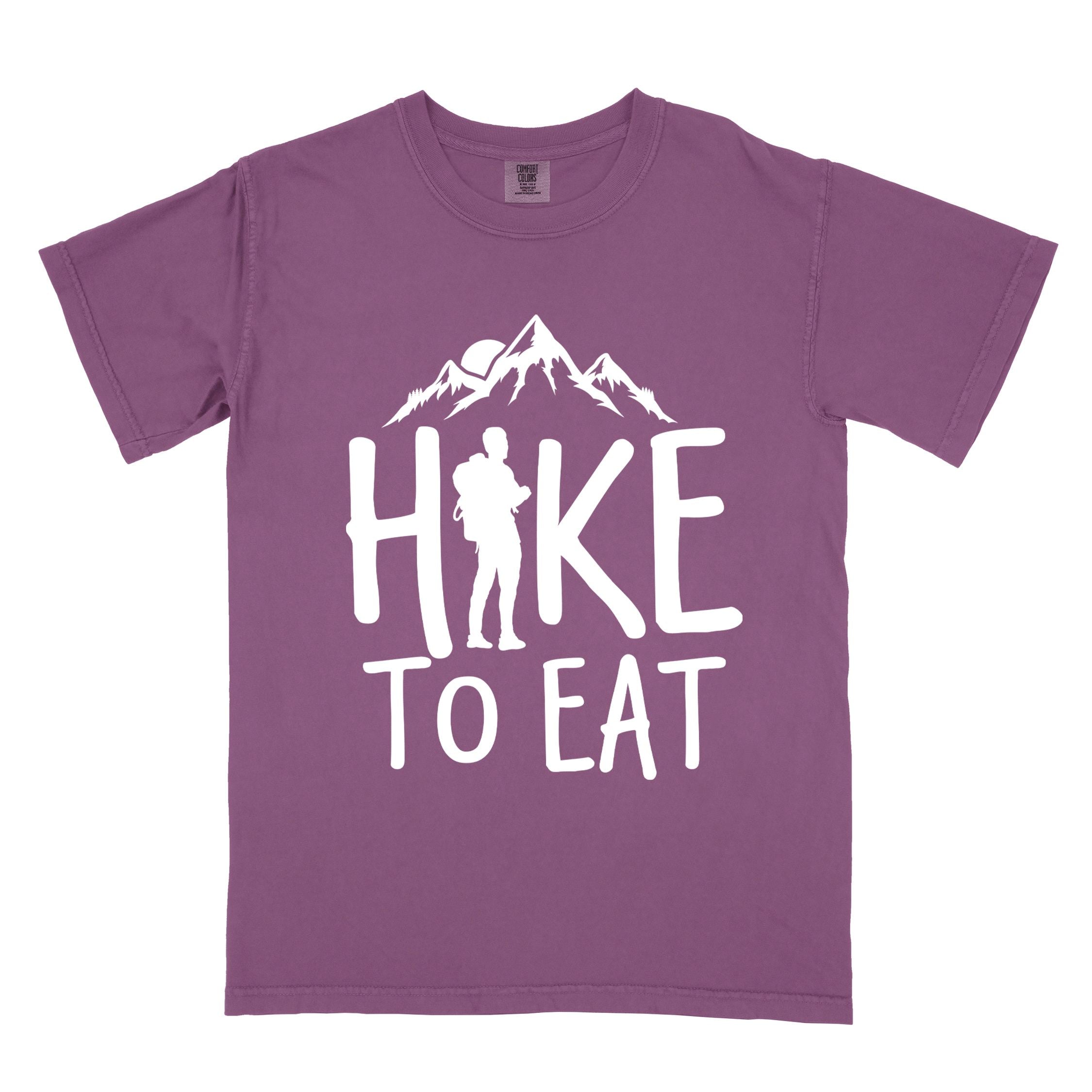 Berry "Hike to Eat" colored statement tee with bold typography, mountains, birds, sunrise, perfect for food motivated individuals.