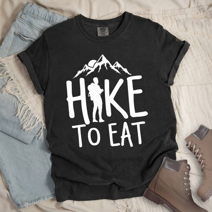 Dark grey shirt with a Hiking design featuring mountain silhouette and shows 'Hike To Eat' phrase in bold text
