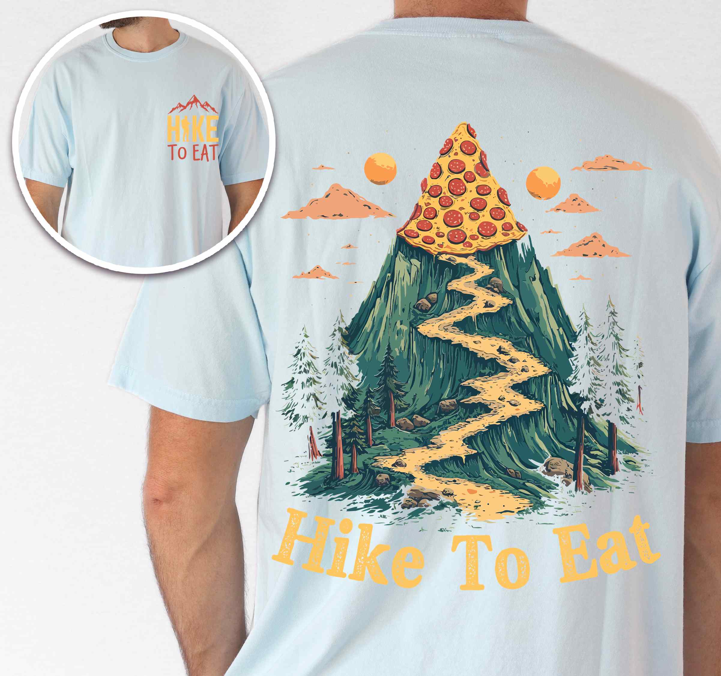 Man wearing Chambray colored vintage tee with front and back design "Hike to Eat" text in cream lettering, mountains, birds, illustrated pizza slice mountain peak, and backpacker for pizza lovers.