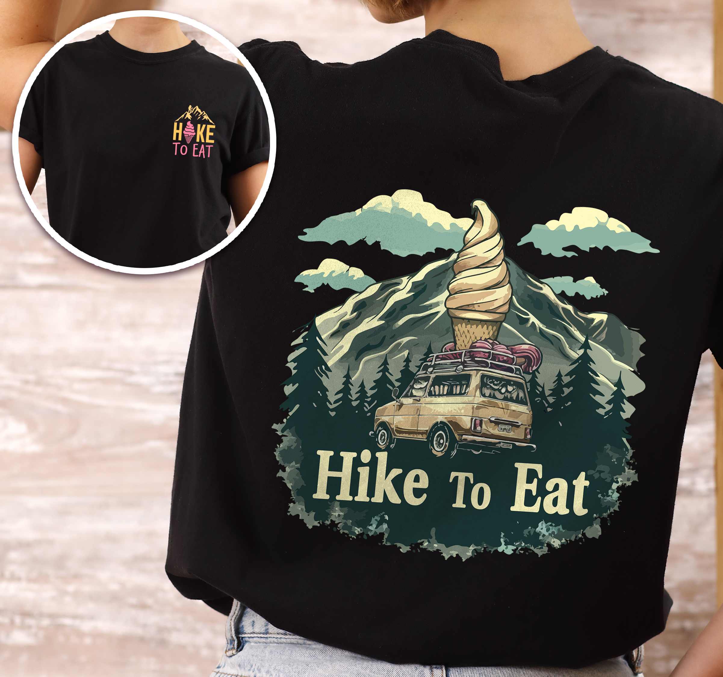 Woman wearing black colored vintage tee with front and back design "Hike to Eat" text in cream lettering, mountains, birds, illustrated icecream cone, and backpacker for dessert lovers.