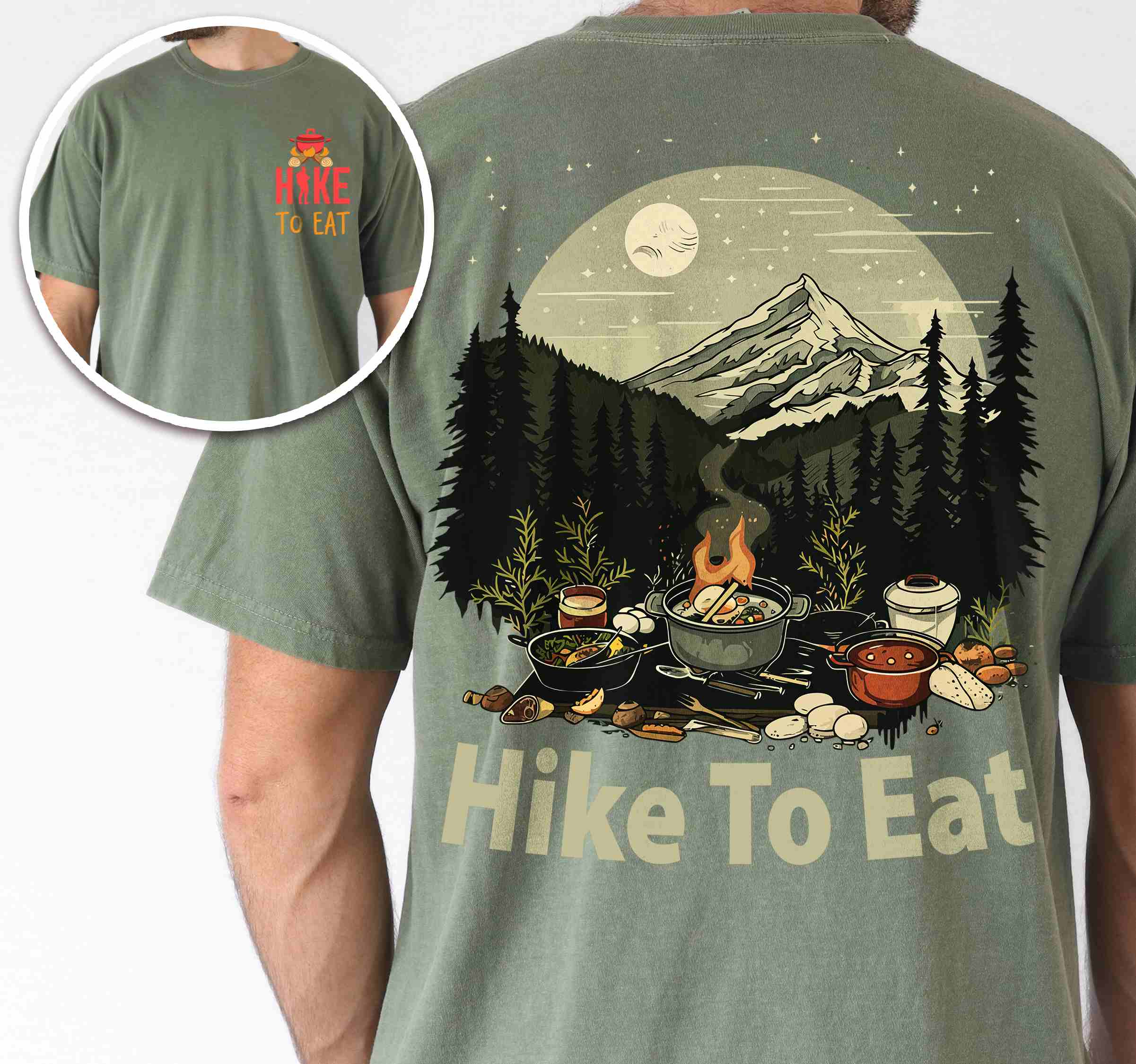 Man wearing moss "Hike to Eat" text in bold lettering front and back design, mountains, birds, illustrated camping feast, and backpacker for campfire cooking enthusiasts.