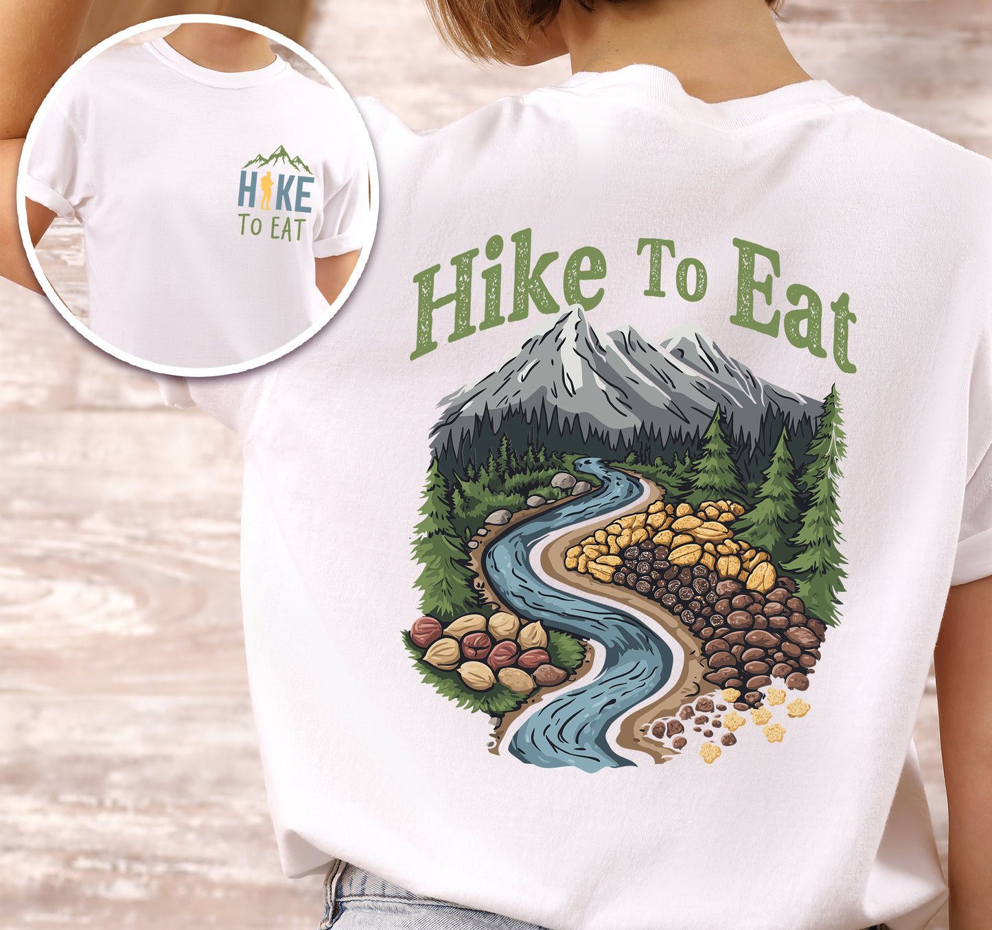White Hike to Eat t-shirt front and back view showing small colorful chest logo and large back design featuring winding river through mountain landscape filled with trail mix nuts, dried fruits, and snacks