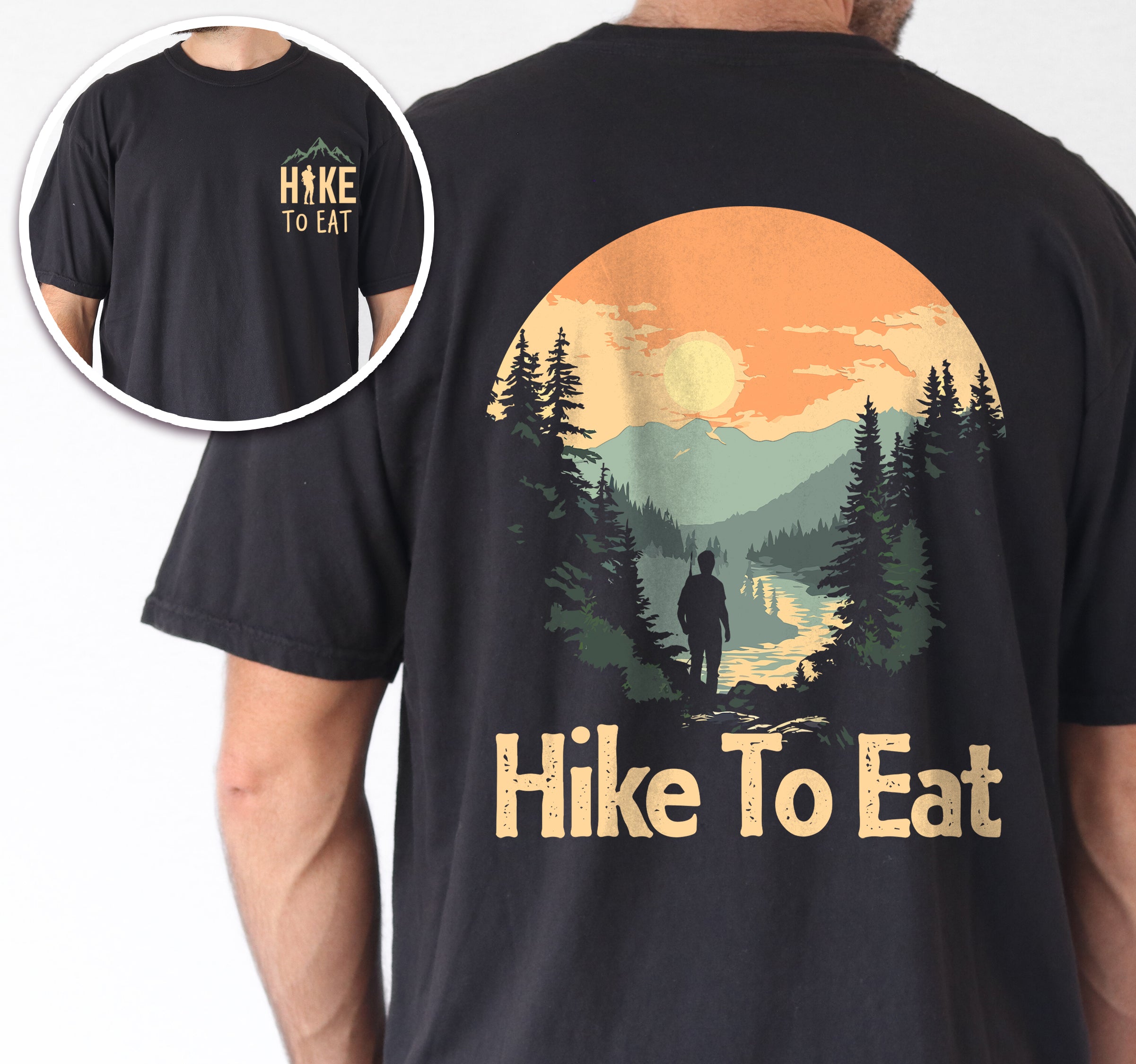 Black Hike to Eat t-shirt front and back view showing small yellow chest logo and large back design featuring circular sunset mountain scene with hiker silhouette by lake, pine trees, and orange sky