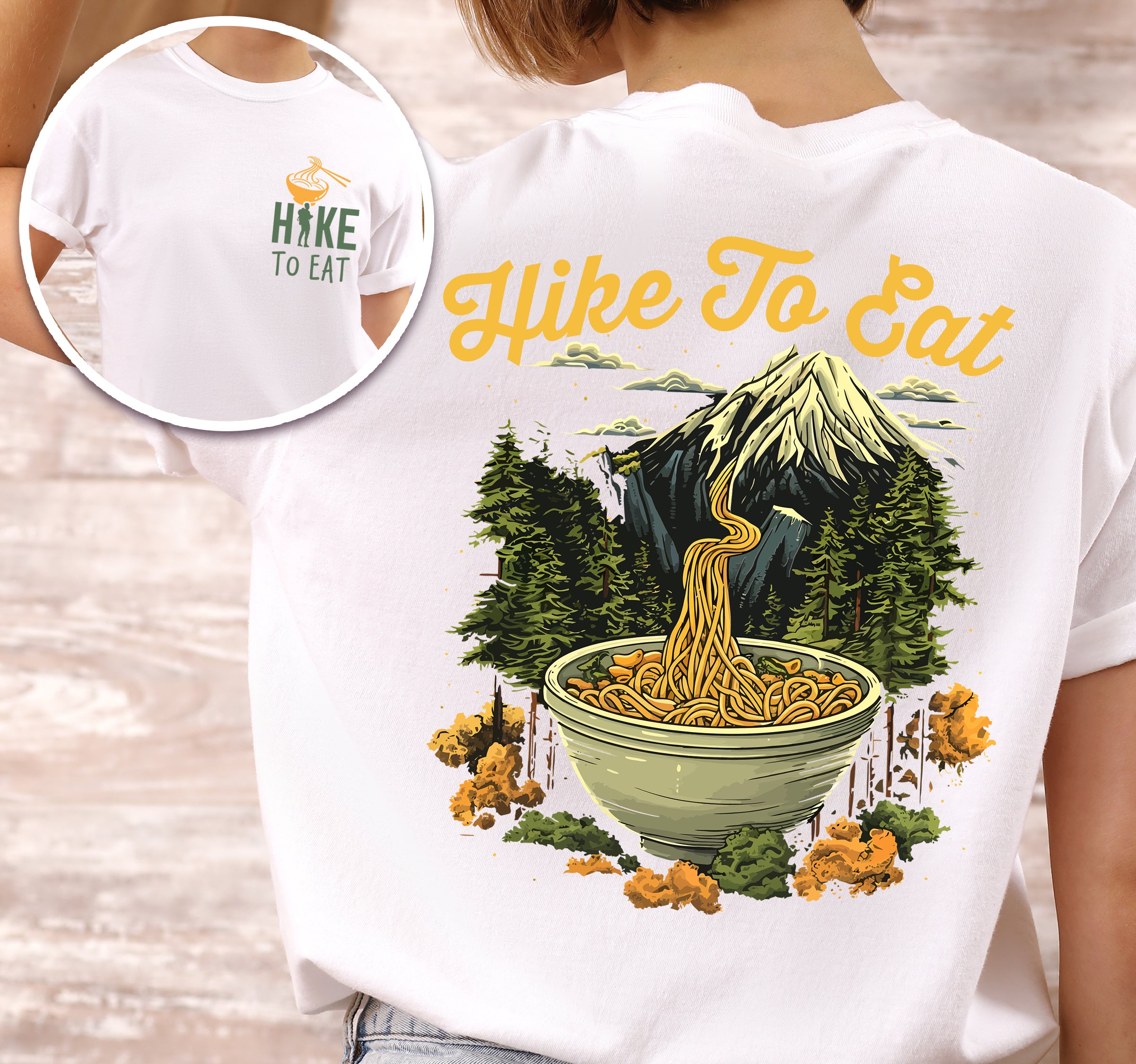 White colored Hike to Eat t-shirt front and back view showing small colorful chest logo and large back design featuring ramen noodle bowl with mountain landscape background and pine trees.
