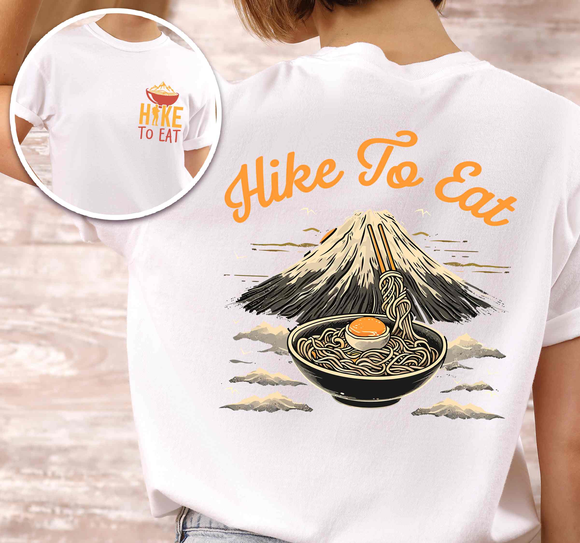 Woman wearing white "Hike to Eat" text in bold lettering front and back design, mountains, birds, illustrated bowl of ramen noodles, and backpacker for ramen lovers.