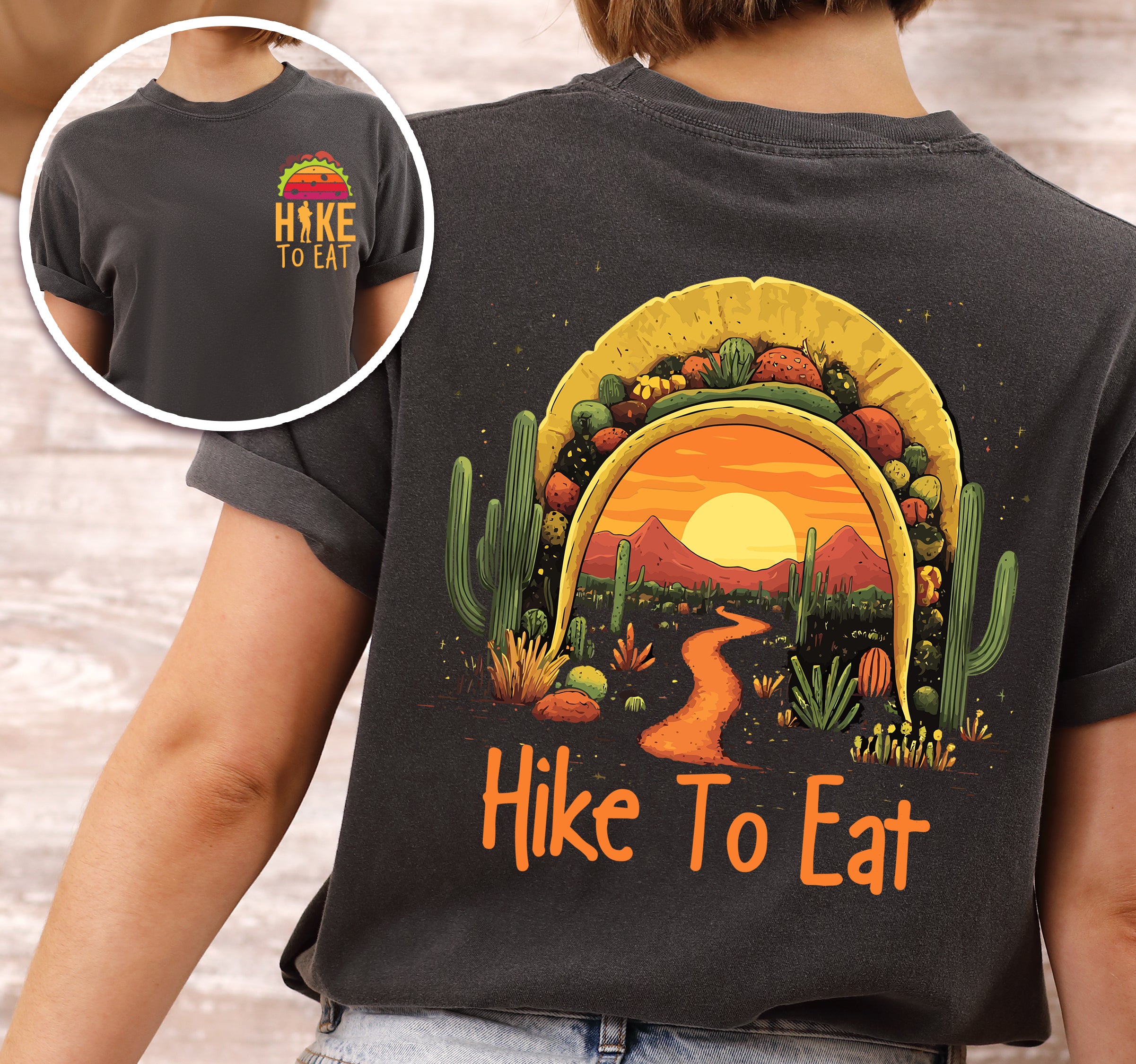 Pepper (Dark Gray) Hike to Eat t-shirt front and back view showing small colorful taco above chest logo and large back design featuring taco shell silhouette filled with orange sunset over desert landscape, winding hiking trail, tall saguaro cacti, desert plants, and starry night sky.