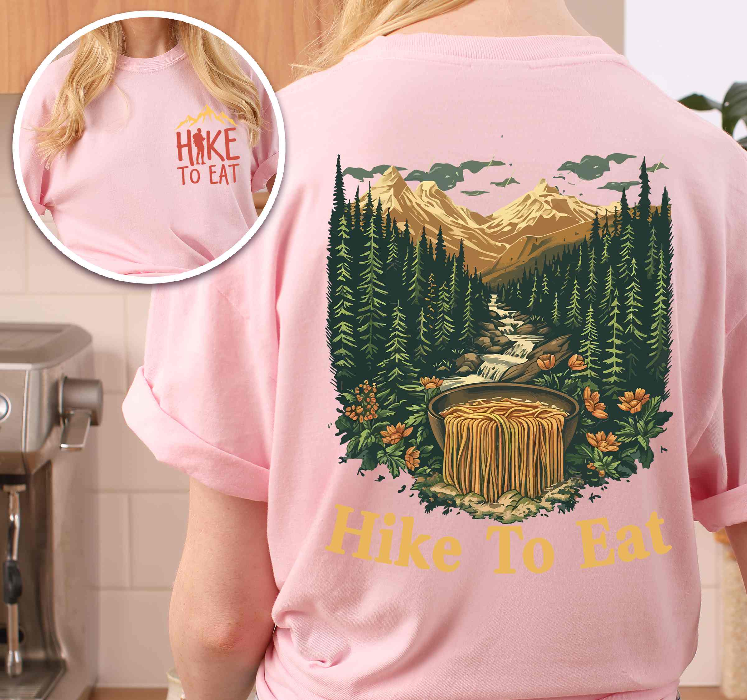 Woman wearing blossom "Hike to Eat" text in cream lettering front and back design, mountains, birds, illustrated bowl of ramen noodles, and backpacker for ramen lovers.