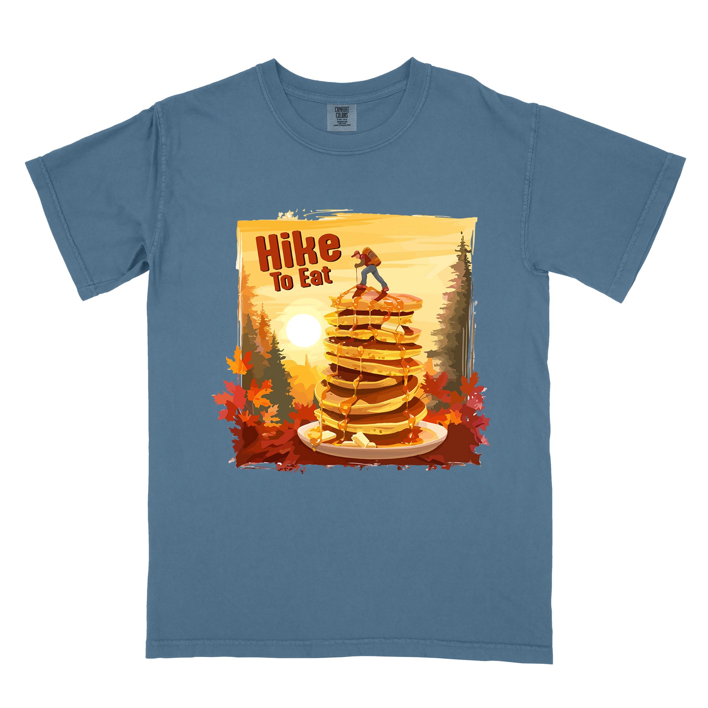 Blue jean "Hike to Eat" colored vintage statement tee with text in bold lettering, mountains, birds, silhouette, illustrated stack of pancake, and perfect for breakfast lovers.