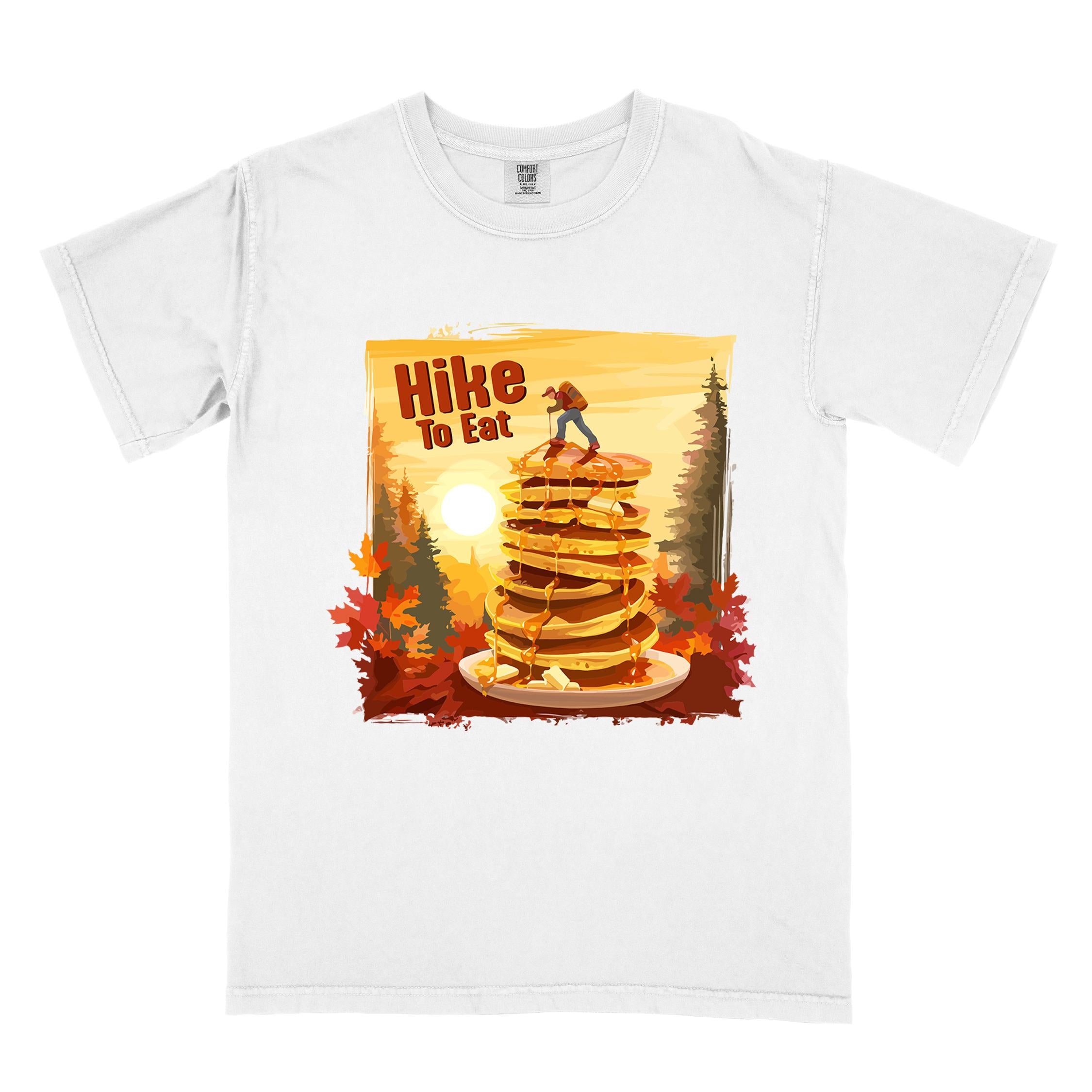 White "Hike to Eat" colored vintage statement tee with text in Bold lettering, mountains, birds, silhouette, illustrated stack of pancake, and perfect for breakfast lovers.