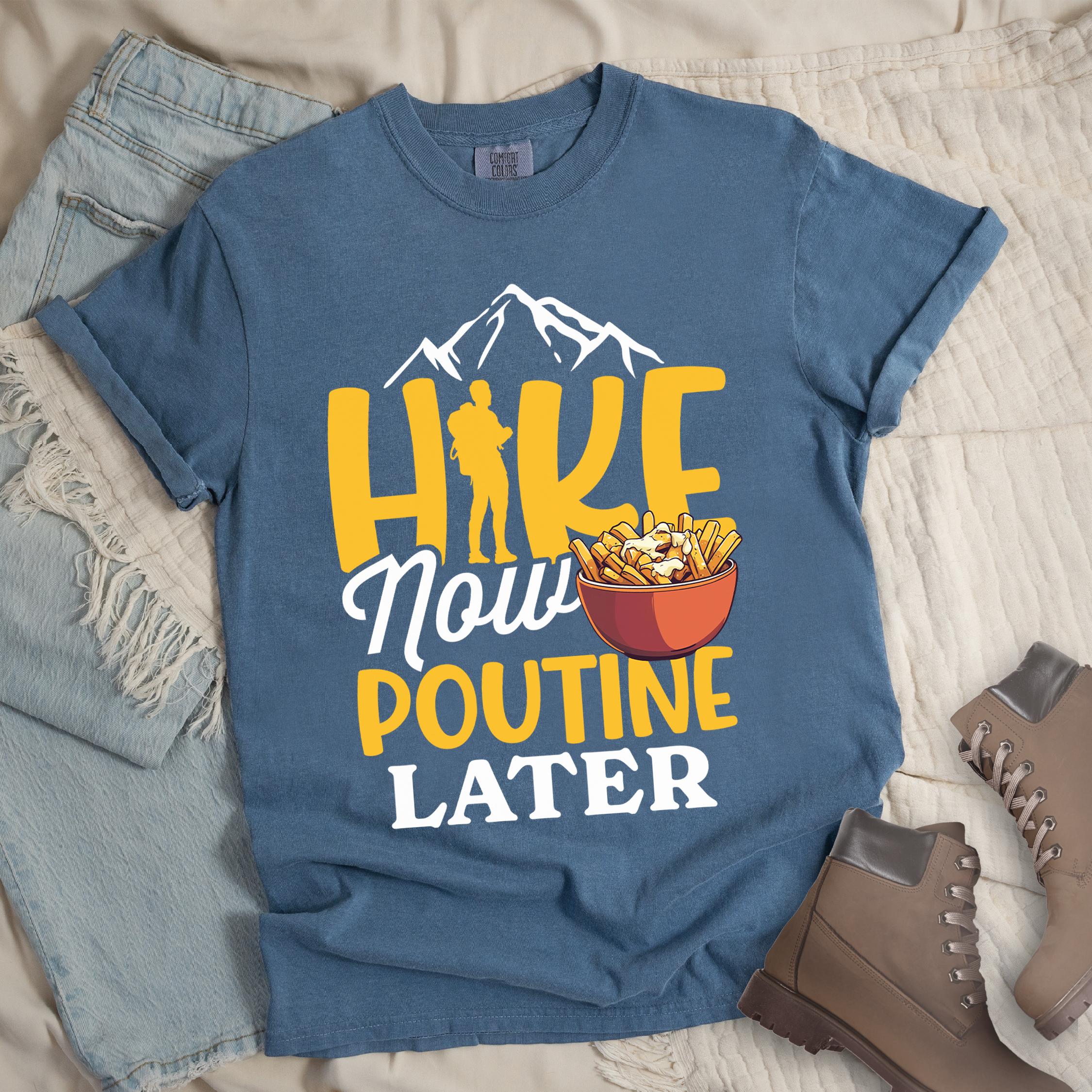 Dark blue shirt with the text “Hike Now Poutine Later” featuring a hiker silhouette, mountain outline, and a bowl of poutine with fries, cheese curds, and gravy.