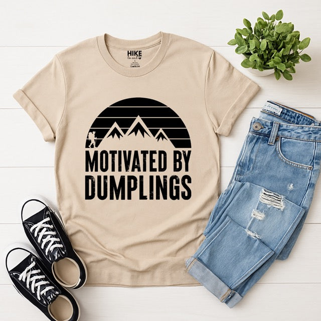 sand (beige) colored Motivated by Dumplings retro statement tee with sunset design, mountain peaks, and hiker silhouette for dumpling lovers