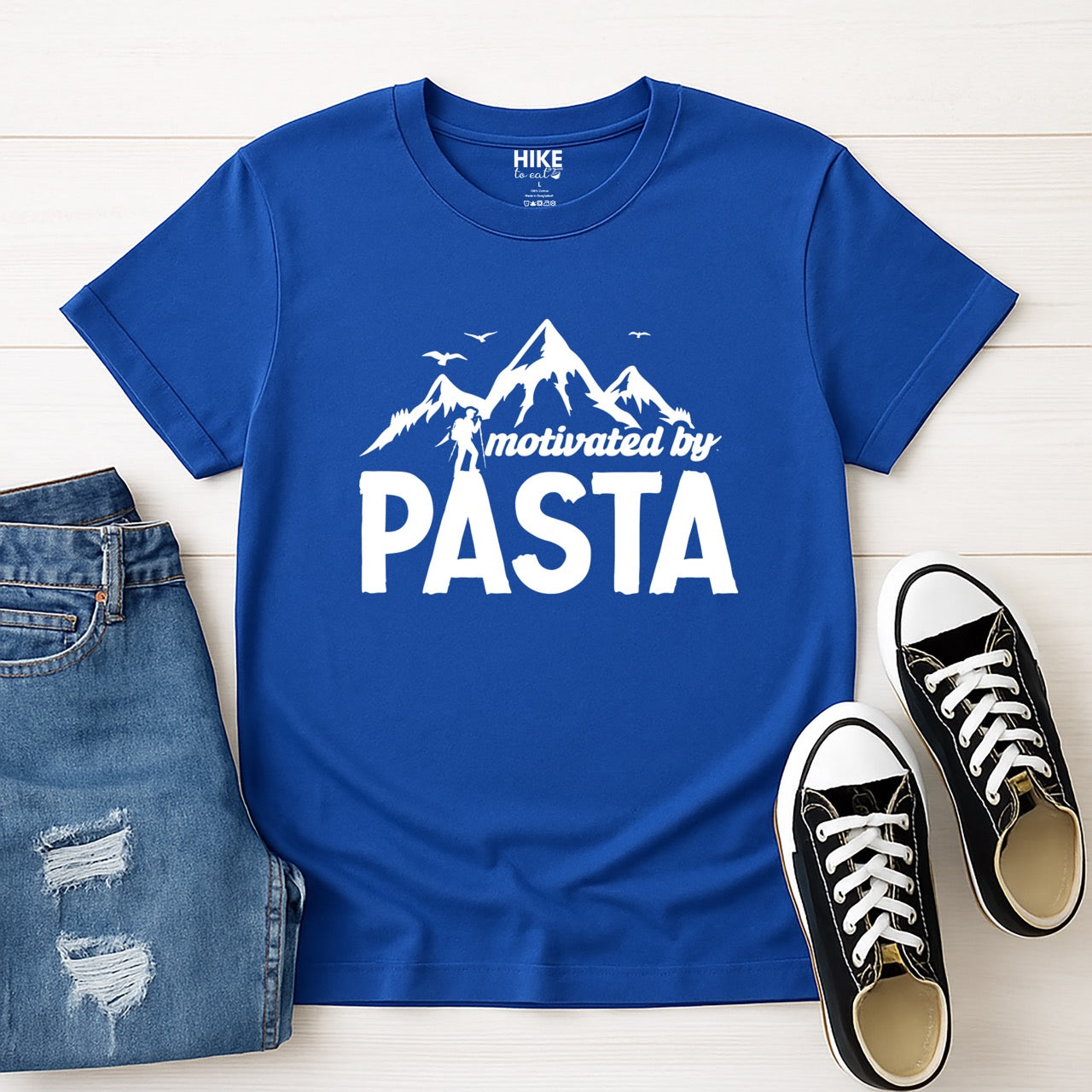 royal (blue) motivated by Pasta statement tee with mountains, birds, and hiker silhouette for pasta enthusiasts and hikers with jeans and shoes