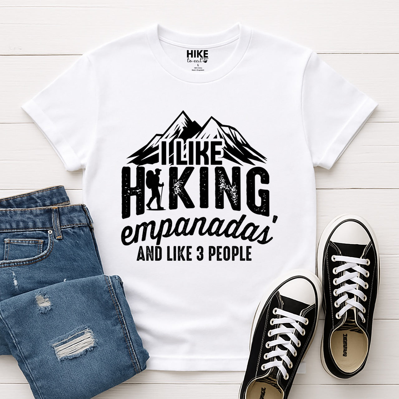 white I like Hiking, Empanadas and like 3 People funny introvert statement tee with mountain peaks, hiker silhouette, and distressed typography for empanada-loving outdoor enthusiasts and hikers with shoes and jeans