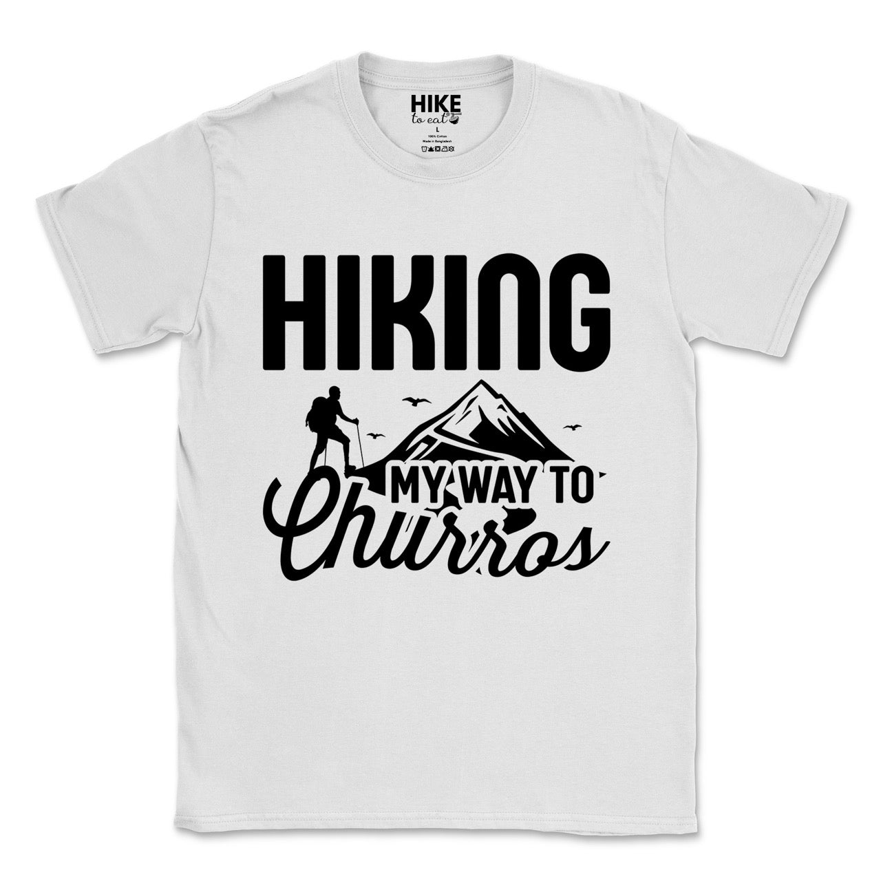 white Hiking my way to Churros statement tee with bold typography, script lettering, mountain peaks, hiker silhouette, and flying birds for Spanish dessert-loving outdoor enthusiasts, hikers and foodies