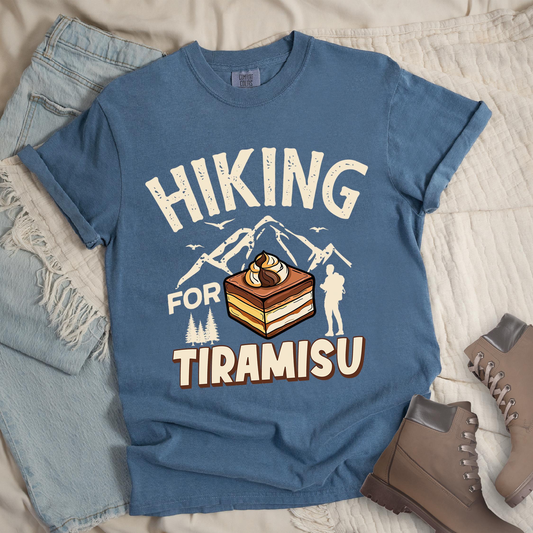 Dark blue shirt with the text “Hiking for Tiramisu” featuring hikers, mountain silhouettes, and a slice of layered tiramisu dessert.