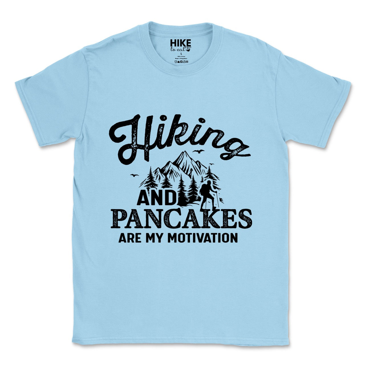 Light Blue Hiking and Pancakes are my motivation statement tee with flowing script typography, bold lettering, mountain peaks, pine trees, hiker silhouette, and flying birds for pancake-loving outdoor enthusiasts, hikers and foodies