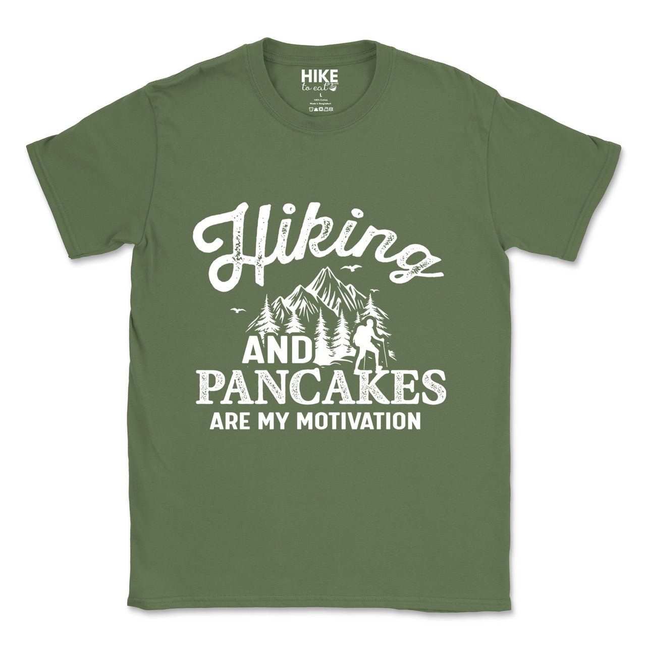 Military Green Hiking and Pancakes are my motivation statement tee with flowing script typography, bold lettering, mountain peaks, pine trees, hiker silhouette, and flying birds for pancake-loving outdoor enthusiasts, hikers and foodies