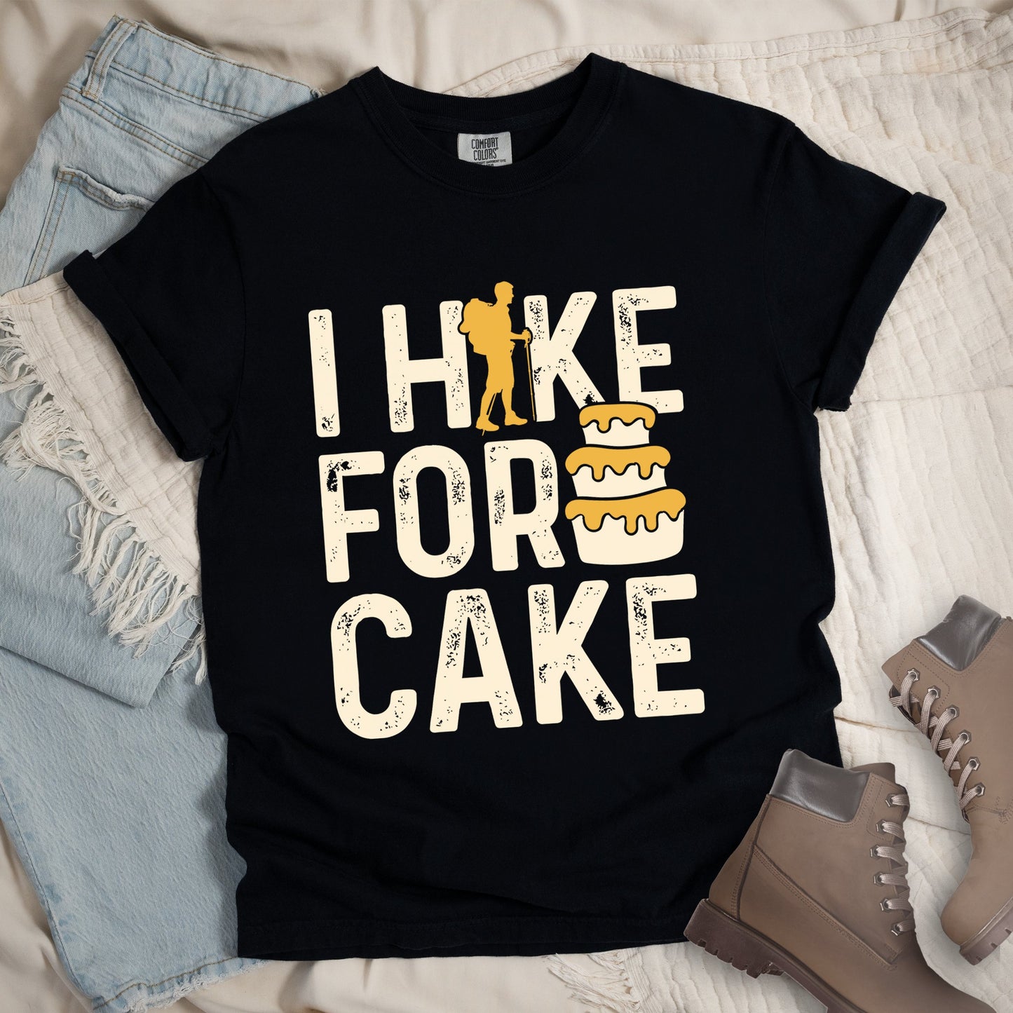 Black shirt with the bold text “I Hike for Cake” and an illustration of a layered cake with frosting.