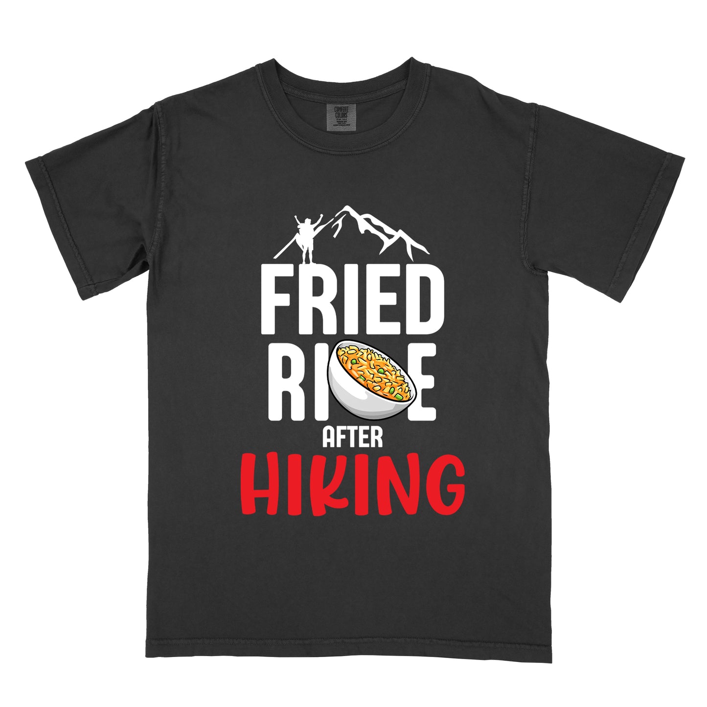 Black t-shirt with text "FRIED RICE AFTER HIKING". The top features white mountain silhouettes with a small hiker figure. "FRIED RICE" appears in large white letters with an illustration of a bowl of fried rice replacing the letter "C" in "RICE", tilted slightly to the right. The word "AFTER" is in small white text, and "HIKING" appears at the bottom in bold red letters.