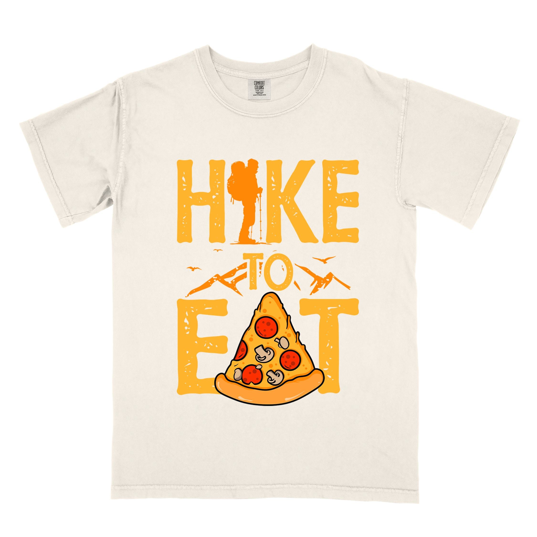 Ivory "Hike to Eat" colored vintage tee with bold typography, birds, mountains, illustrated pizza slice, and backpacker for pizza lovers.