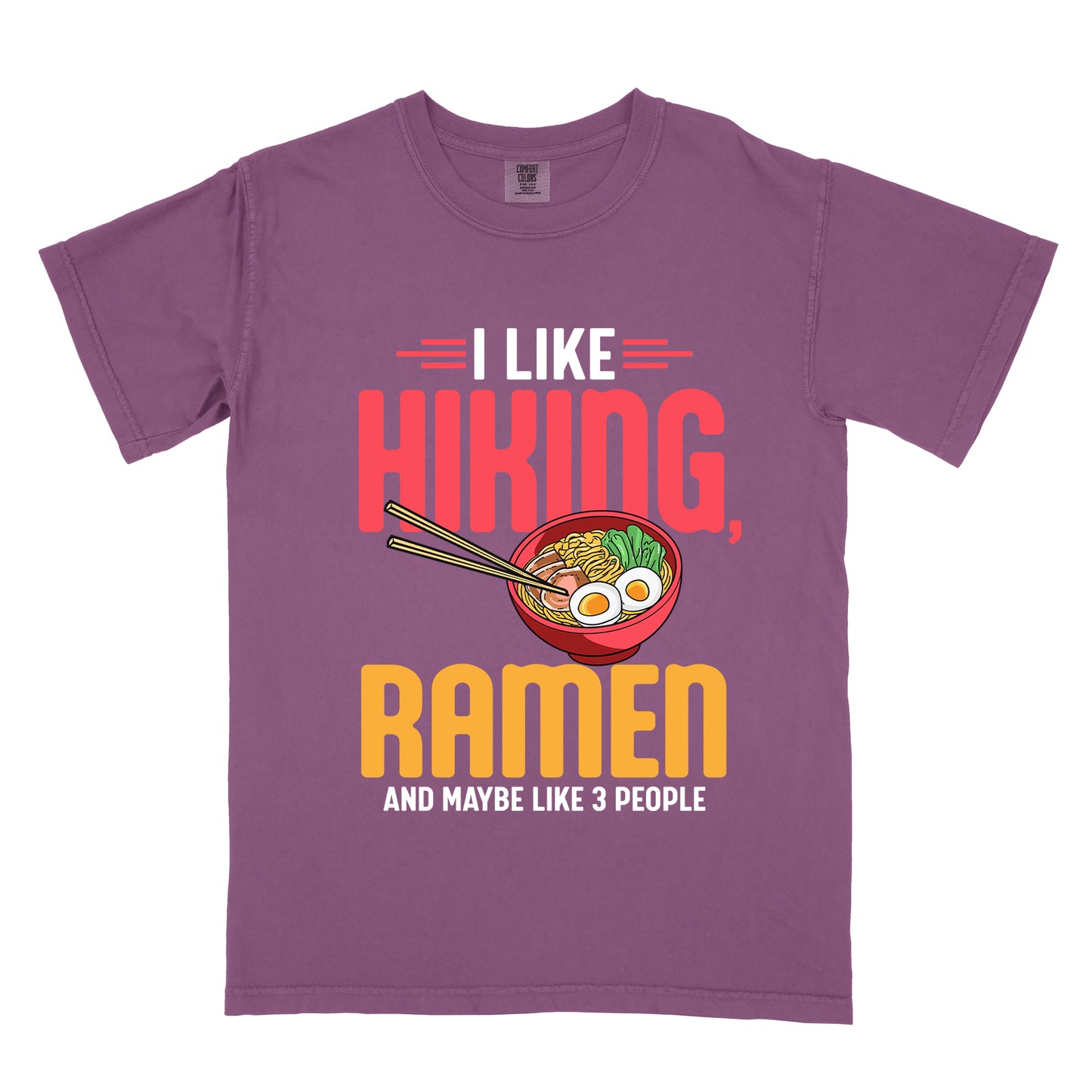 Berry (Dark Violet) t-shirt with text "I LIKE HIKING, RAMEN AND MAYBE LIKE 3 PEOPLE". "I LIKE" appears in white at the top with red decorative lines, "HIKING," in large red letters, "RAMEN" in yellow/orange, and "AND MAYBE LIKE 3 PEOPLE" in white at the bottom. Between "HIKING" and "RAMEN" is a colorful illustration of a red ramen bowl with noodles, egg, and vegetables, with chopsticks.
